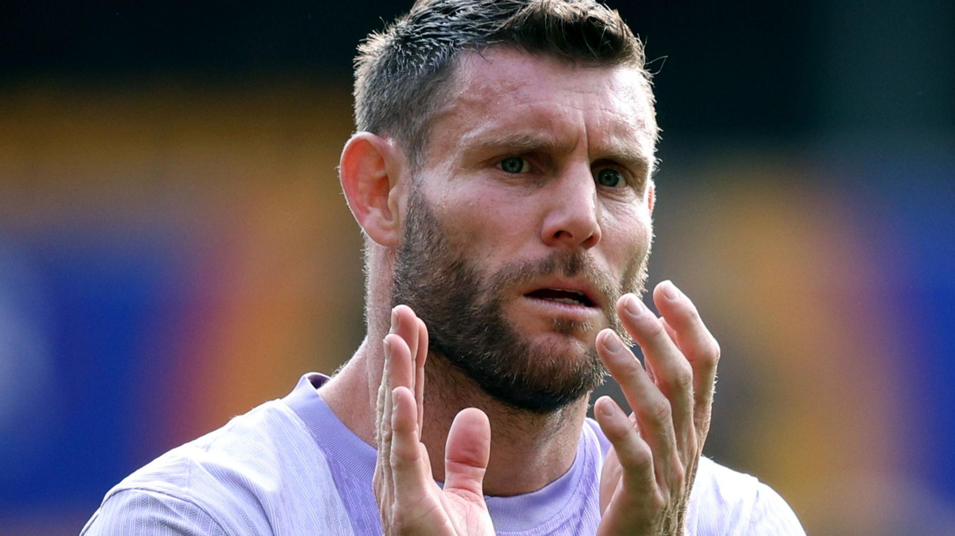 James Milner applauds supporters after a football match
