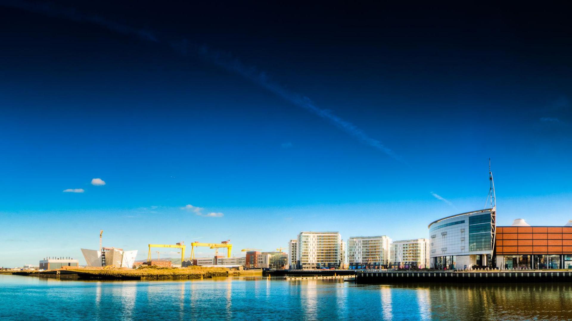 A view across the Lagan of the Titanic Quarter including the Titanic museum, the SSE Arena and the Harland and Wolff cranes