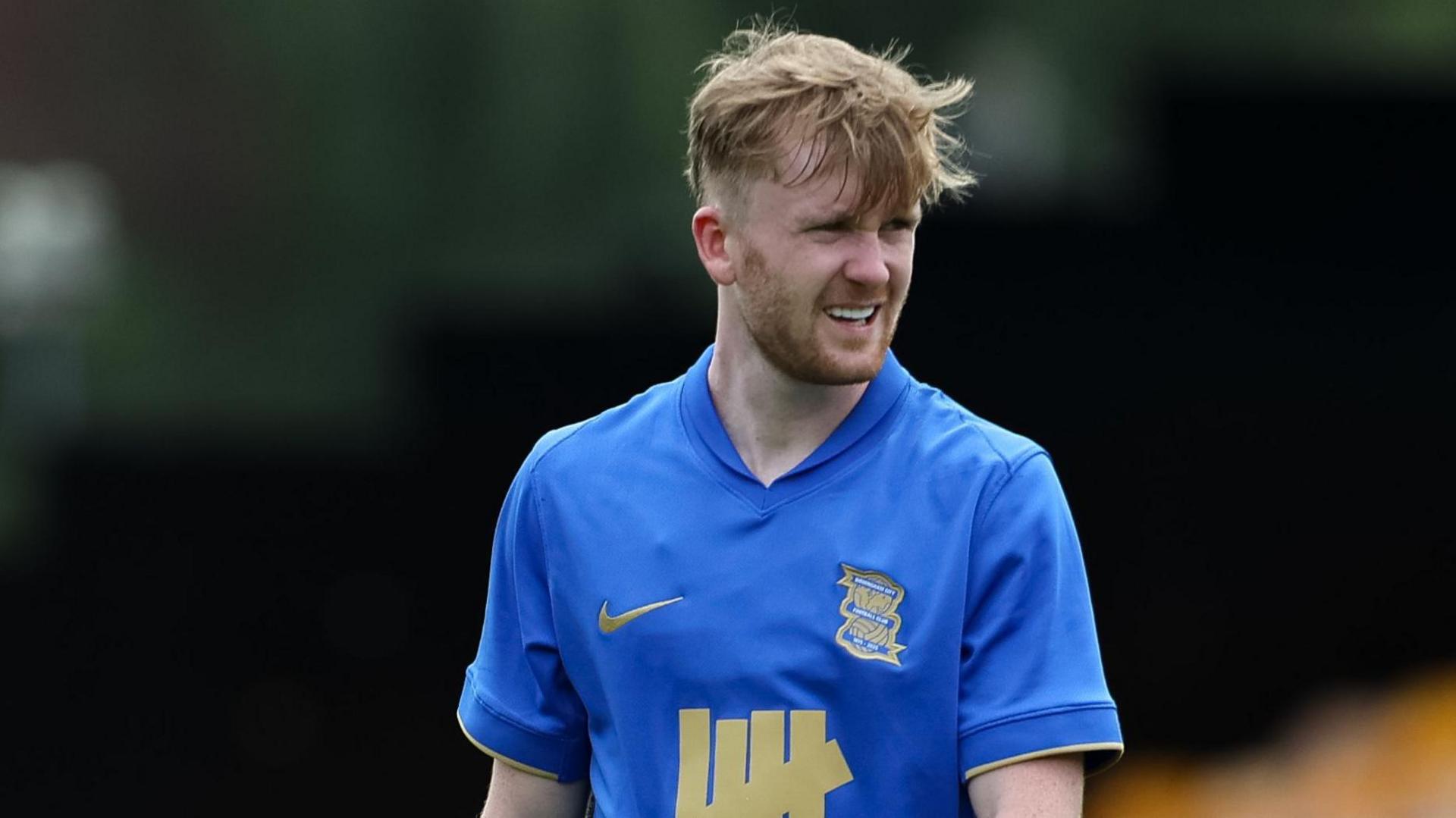 Tommy Doyle stands looking to his left in his blue Birmingham City shirt during a pre-season game