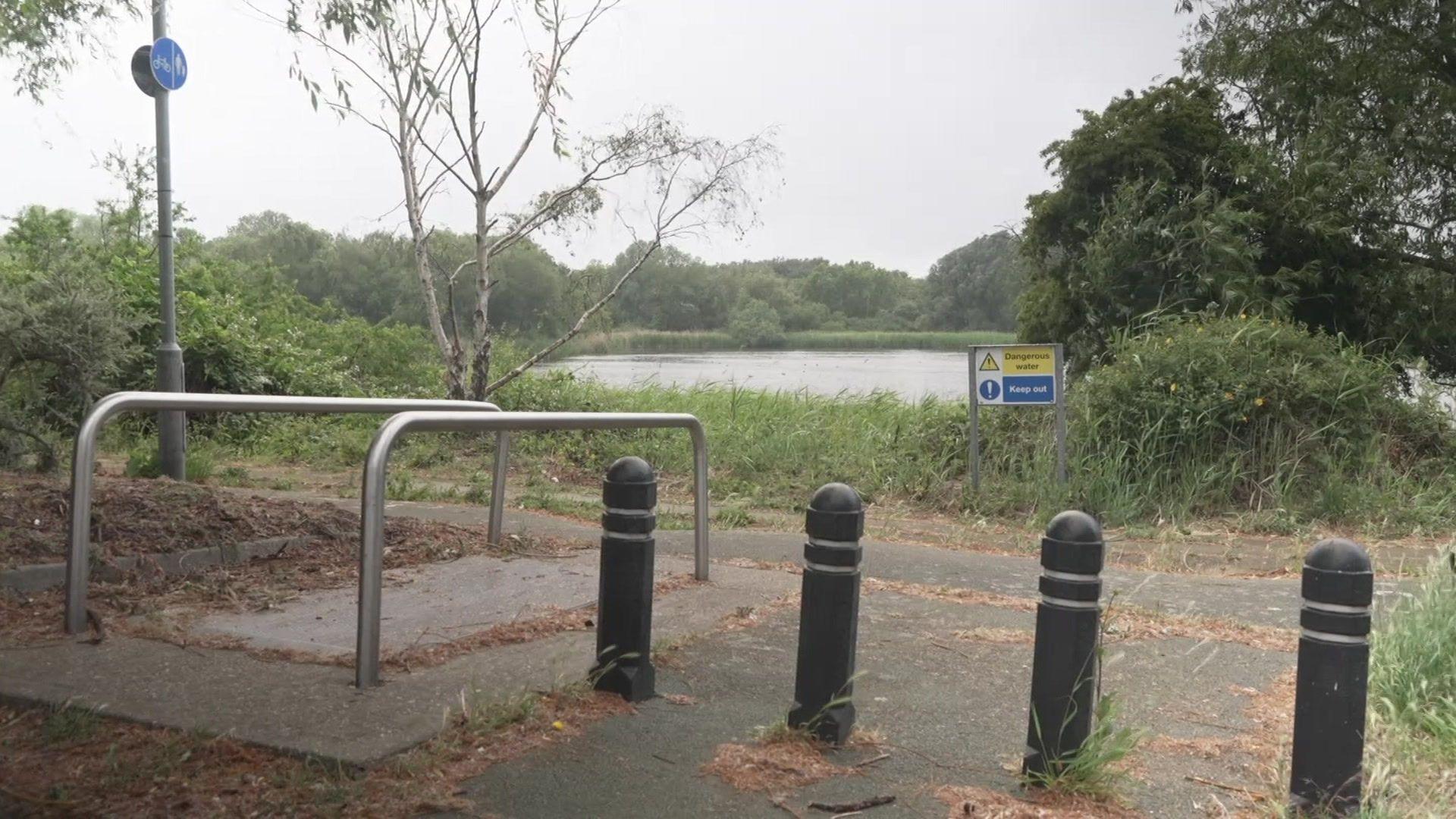A footpath runs alongside a lake