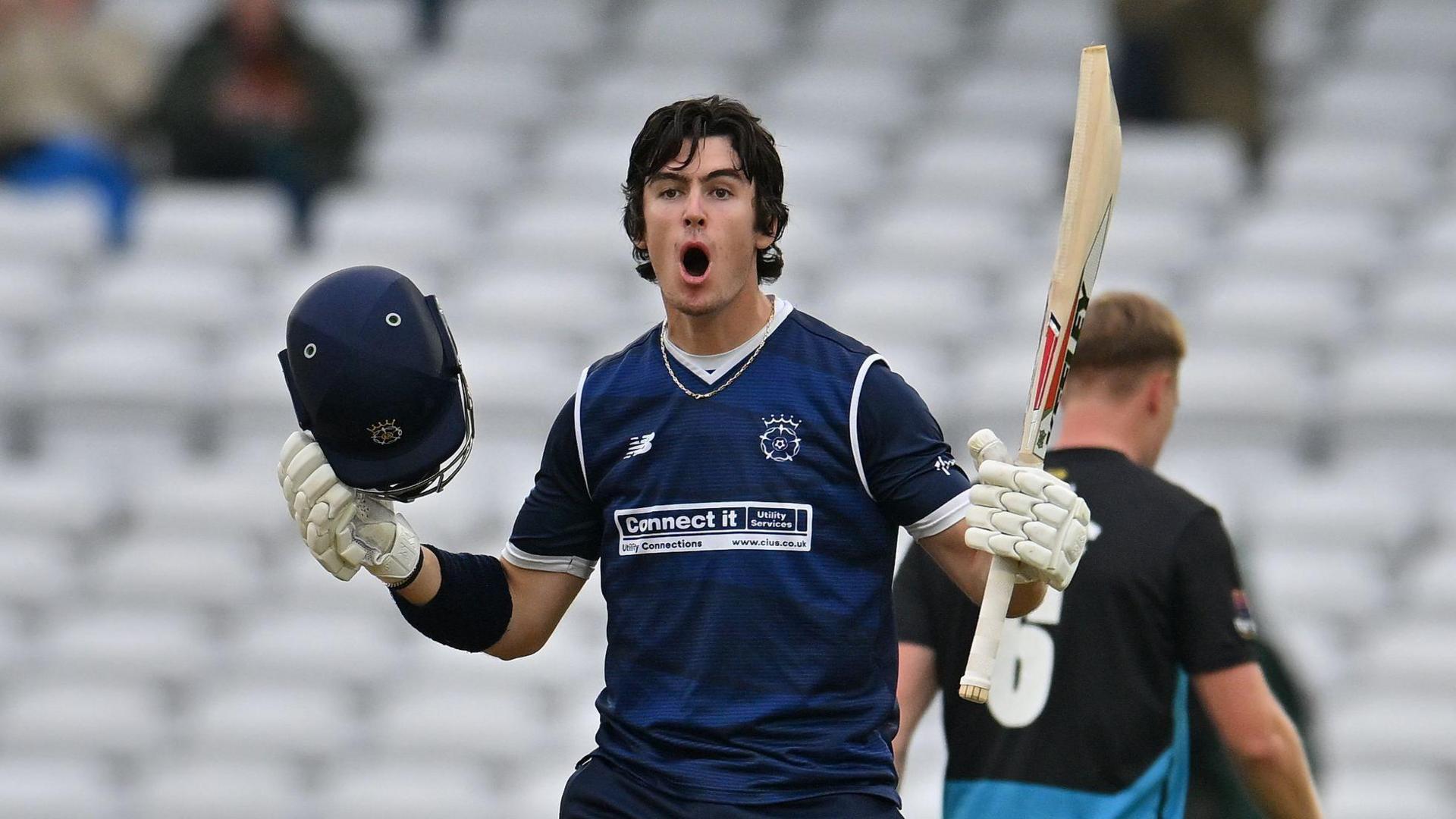 Ali Orr, with his helmet in his right hand and bat in his left, roars as he reaches his century