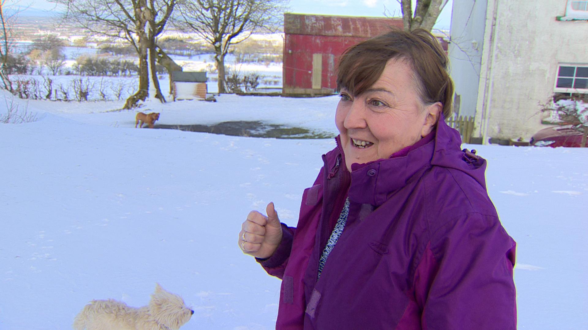 Patricia Ward in snow outside her home