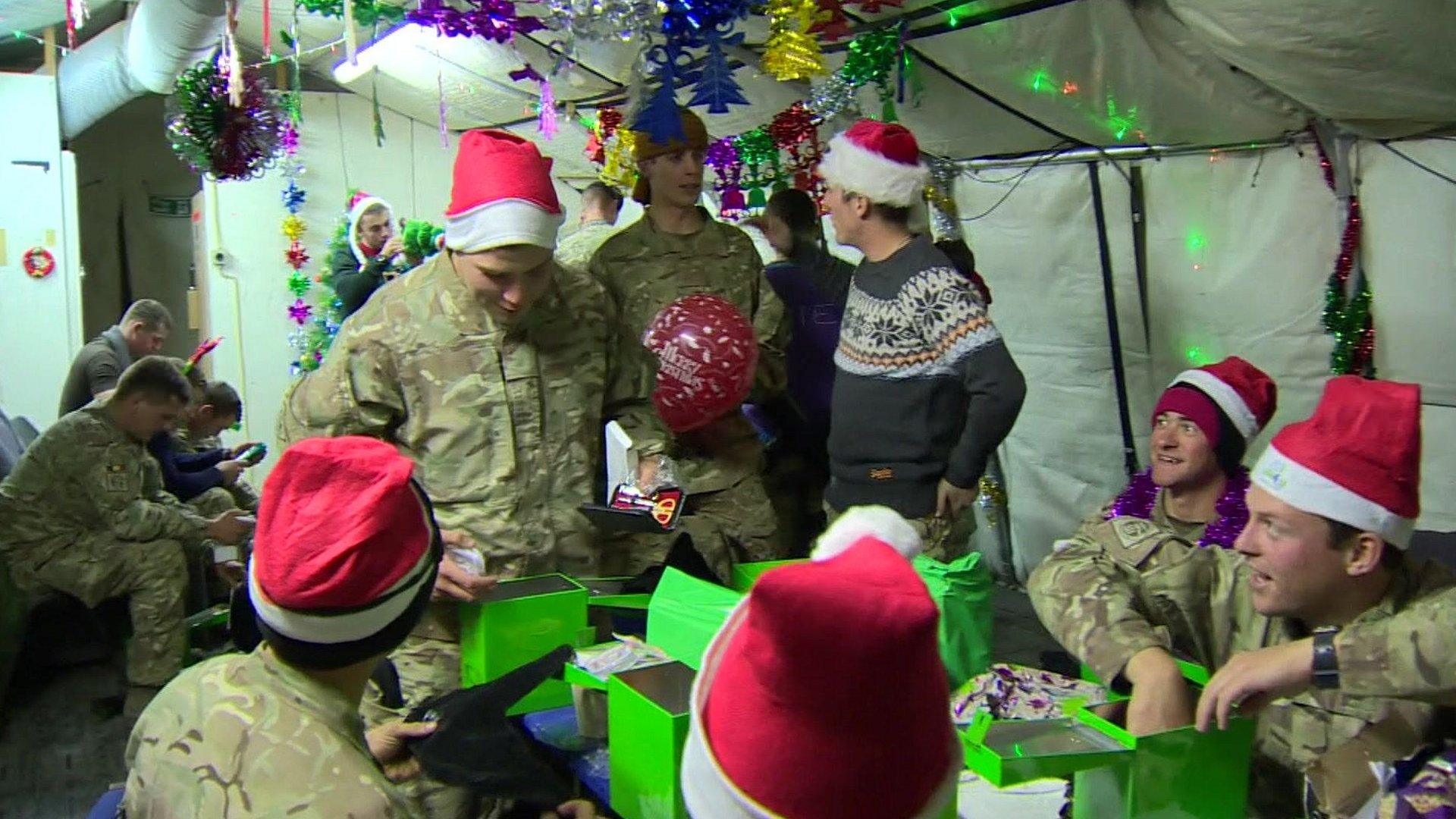 British soldiers looking at Christmas presents at Camp Bastion