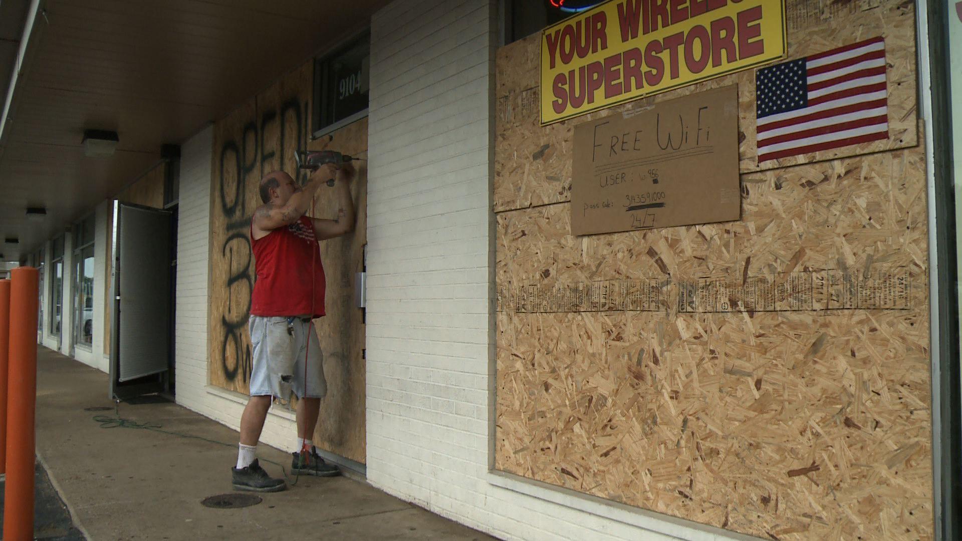 Man boarding up business