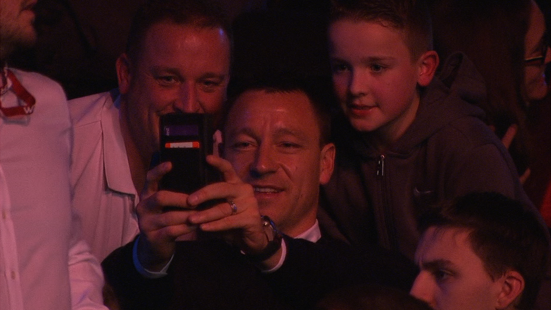 Chelsea captain John Terry takes a number of selfies with fans while watching the Masters snooker