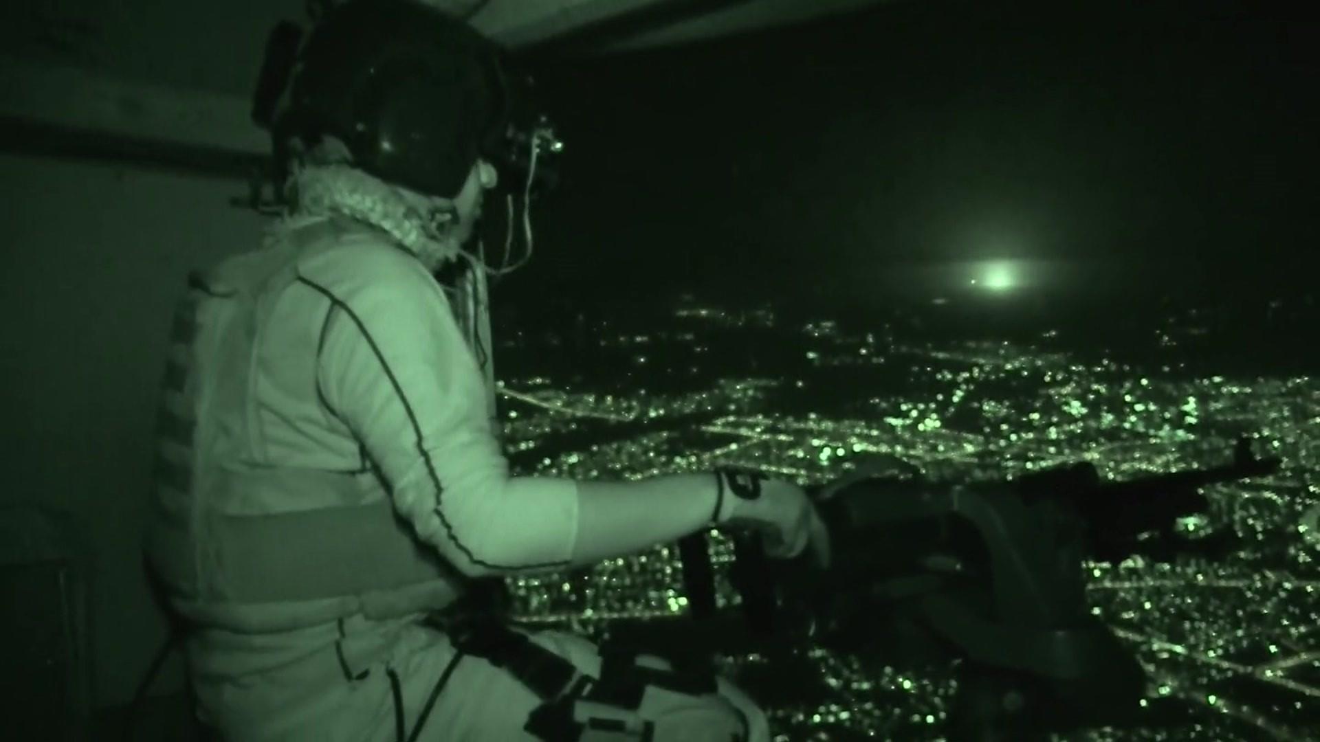 Iraqi army soldier looks out at Mosul from a helicopter