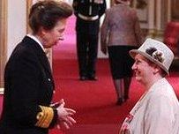 Alison Merrien receiving MBE from Princess Anne