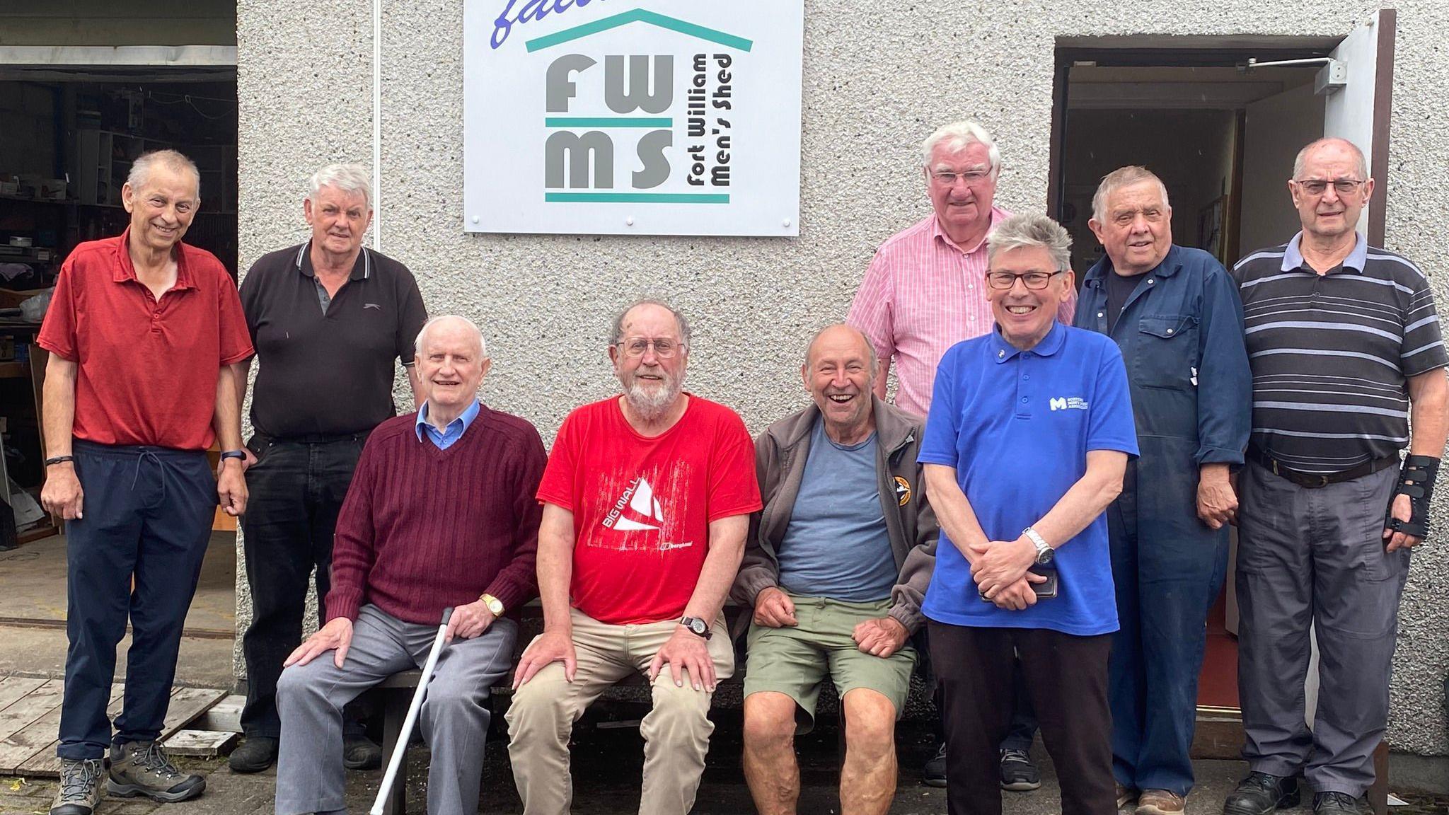 Group of men standing outside SMSA in Fort William