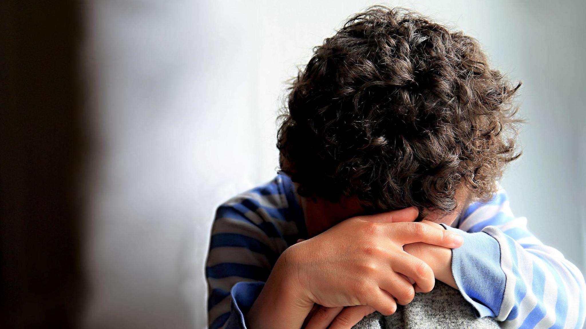 A child with his head in his hands