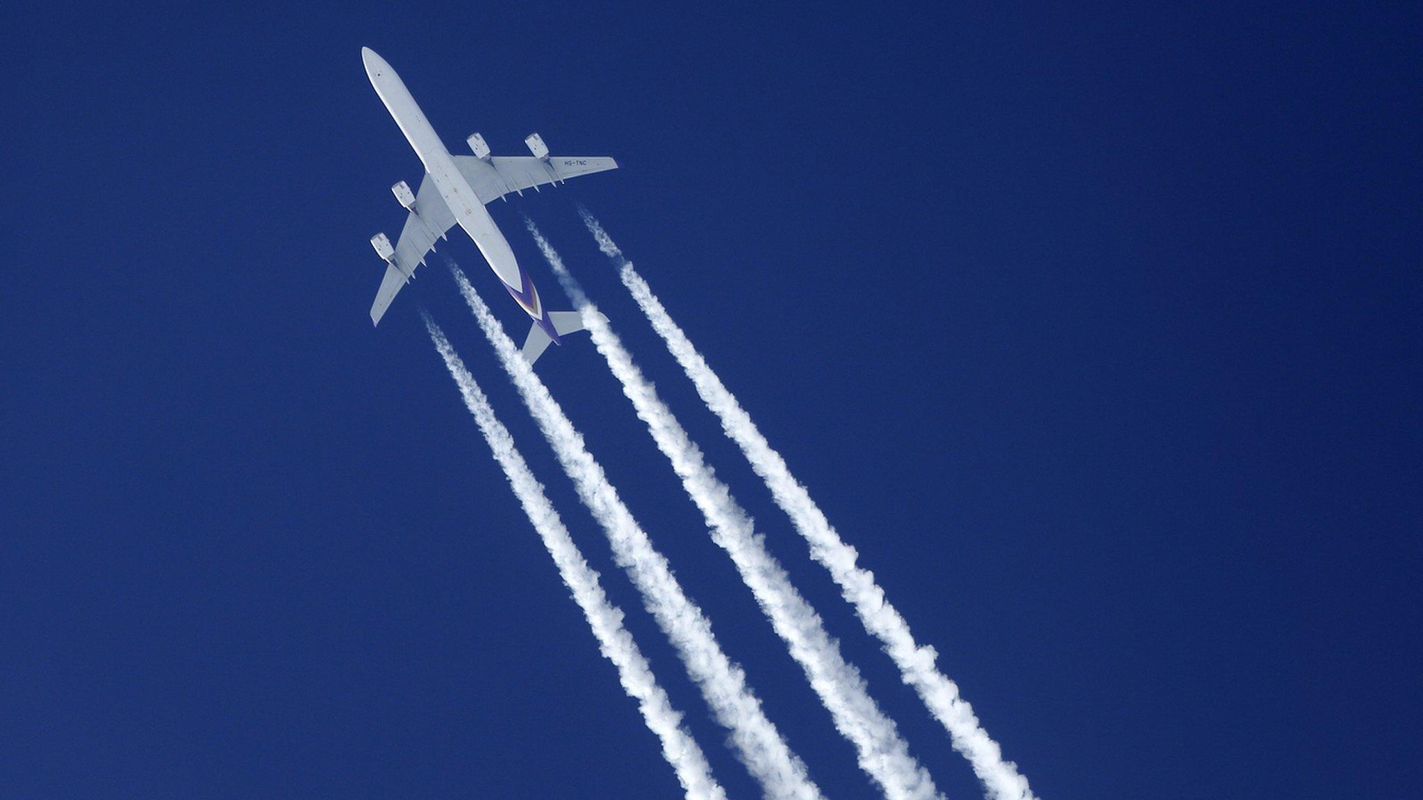 Plane with contrails