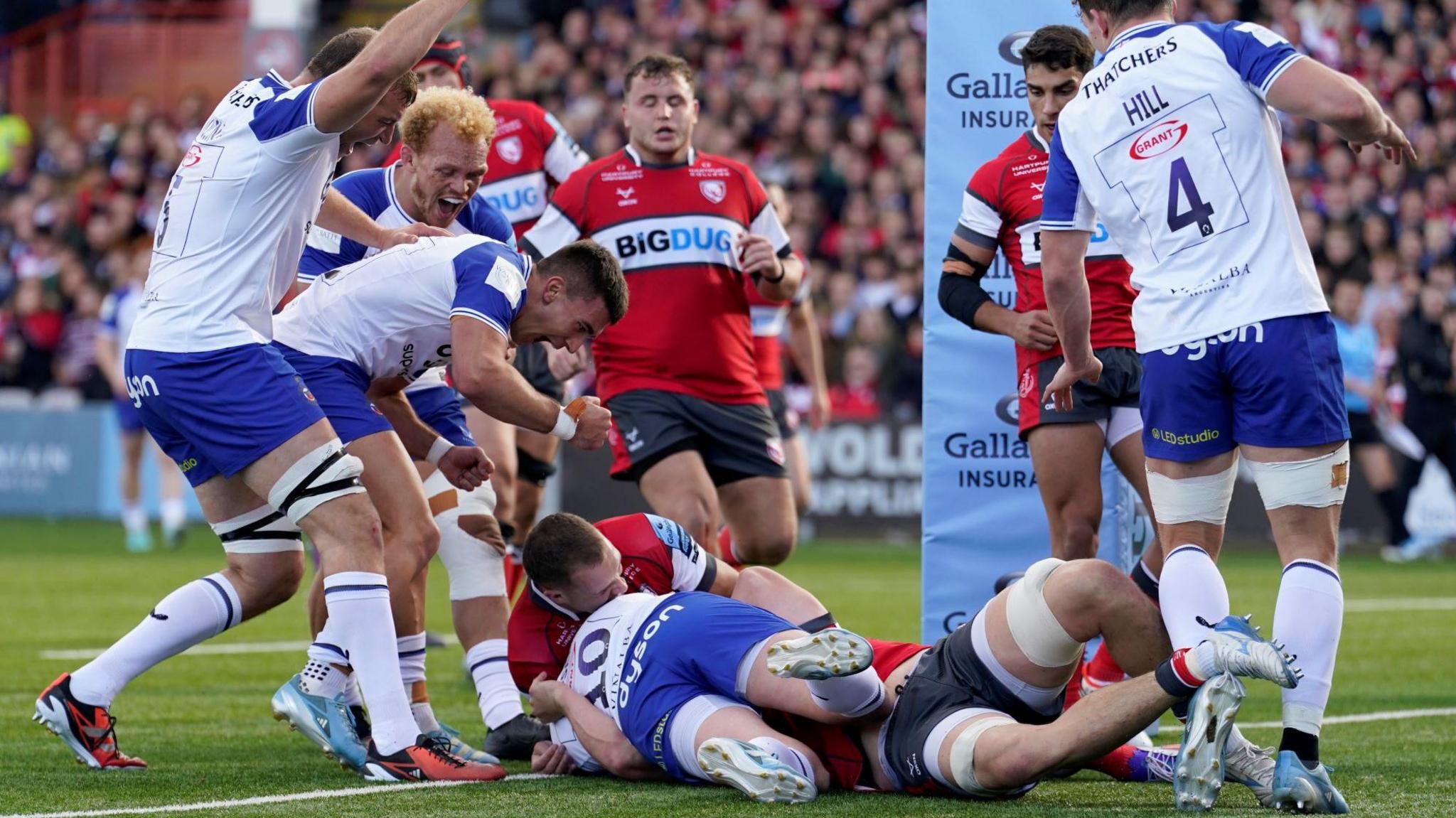 Finn Russell rolls over the line to score a try