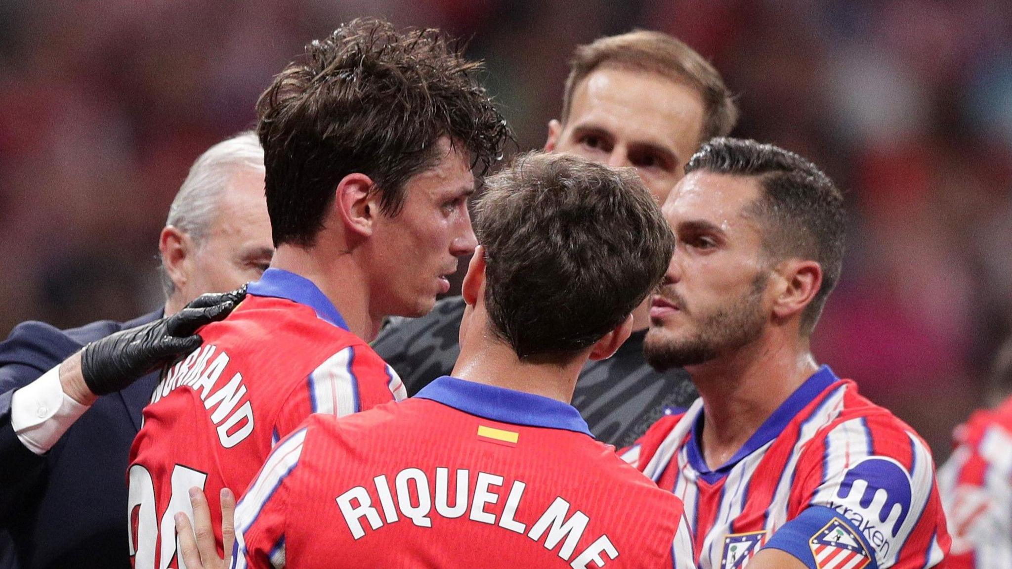 Atletico Madrid's Robin Le Normand receives treatment after a clash of heads during the Madrid derby