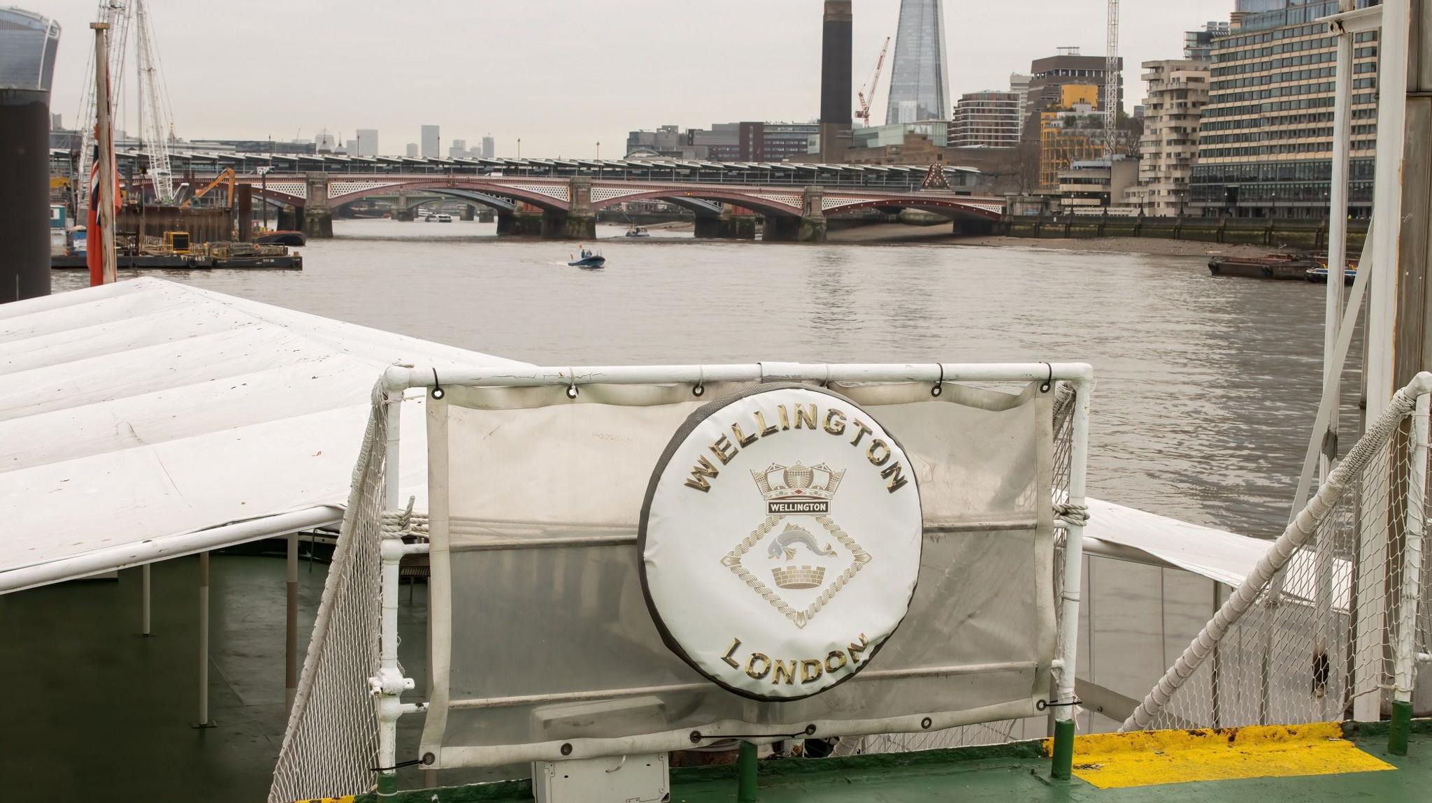 A downstream view from HMS Wellington over the Quarterdeck looking towards the Shard and Canary Wharf