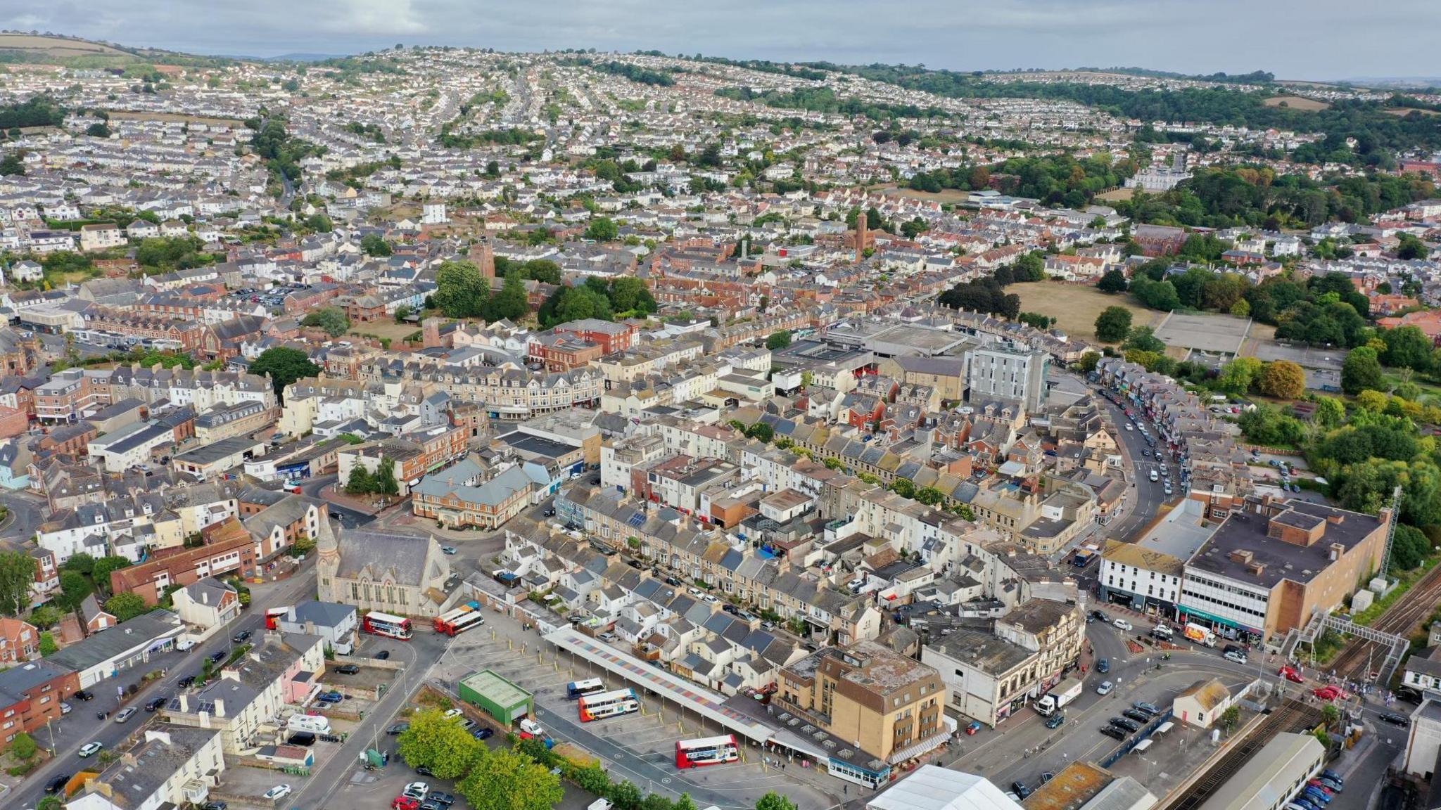An aerial view of Paignton's town centre, with shops, roads and buses in view.