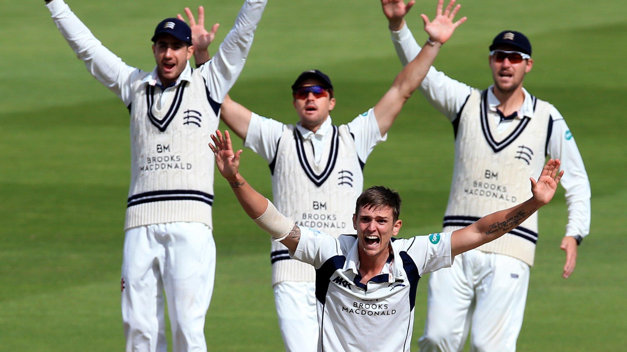 Middlesex paceman Harry Podmore leads his team in an unsuccessful appeal against Warwickshire at Edgbaston