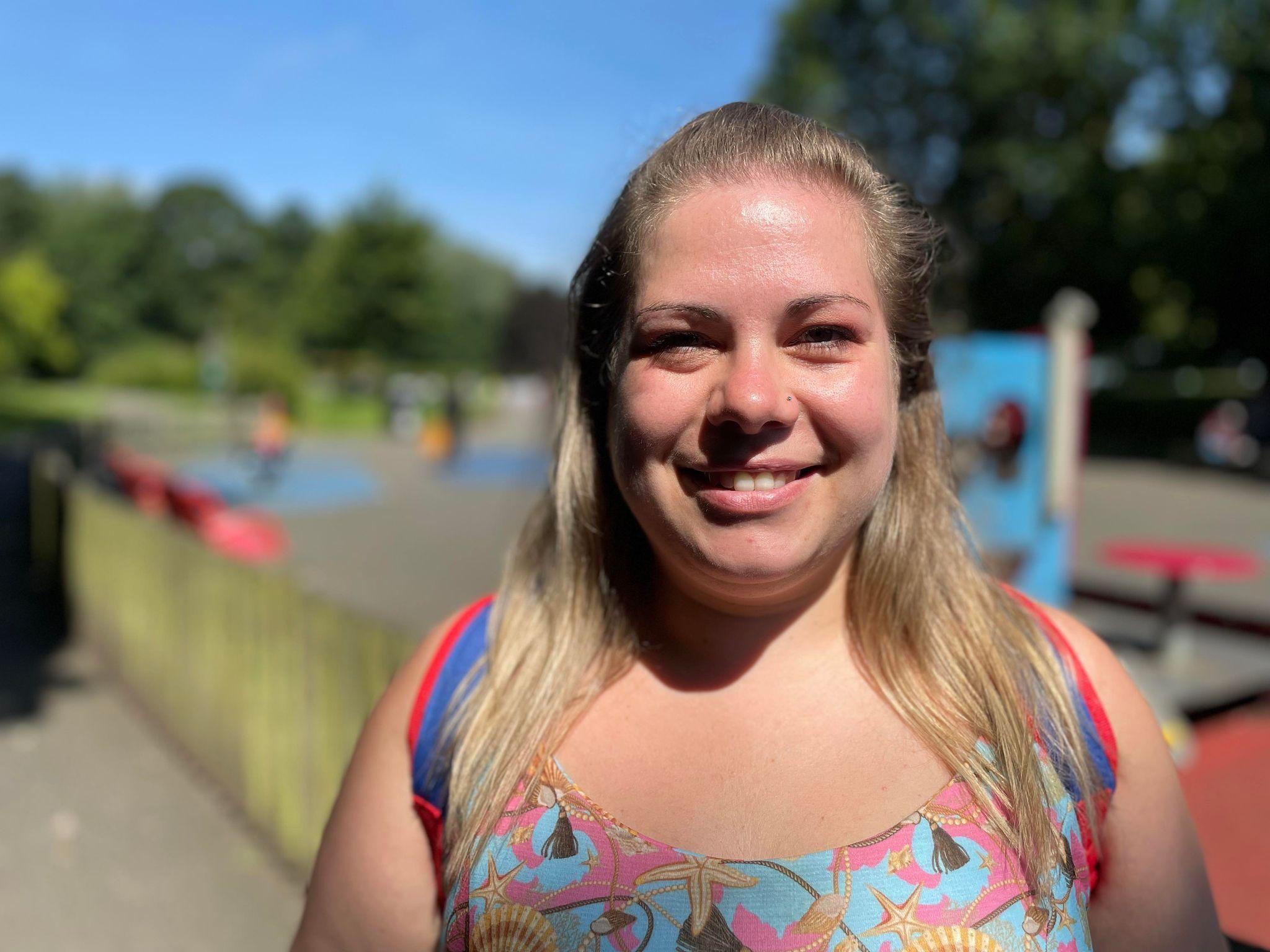 Woman standing in front of play area