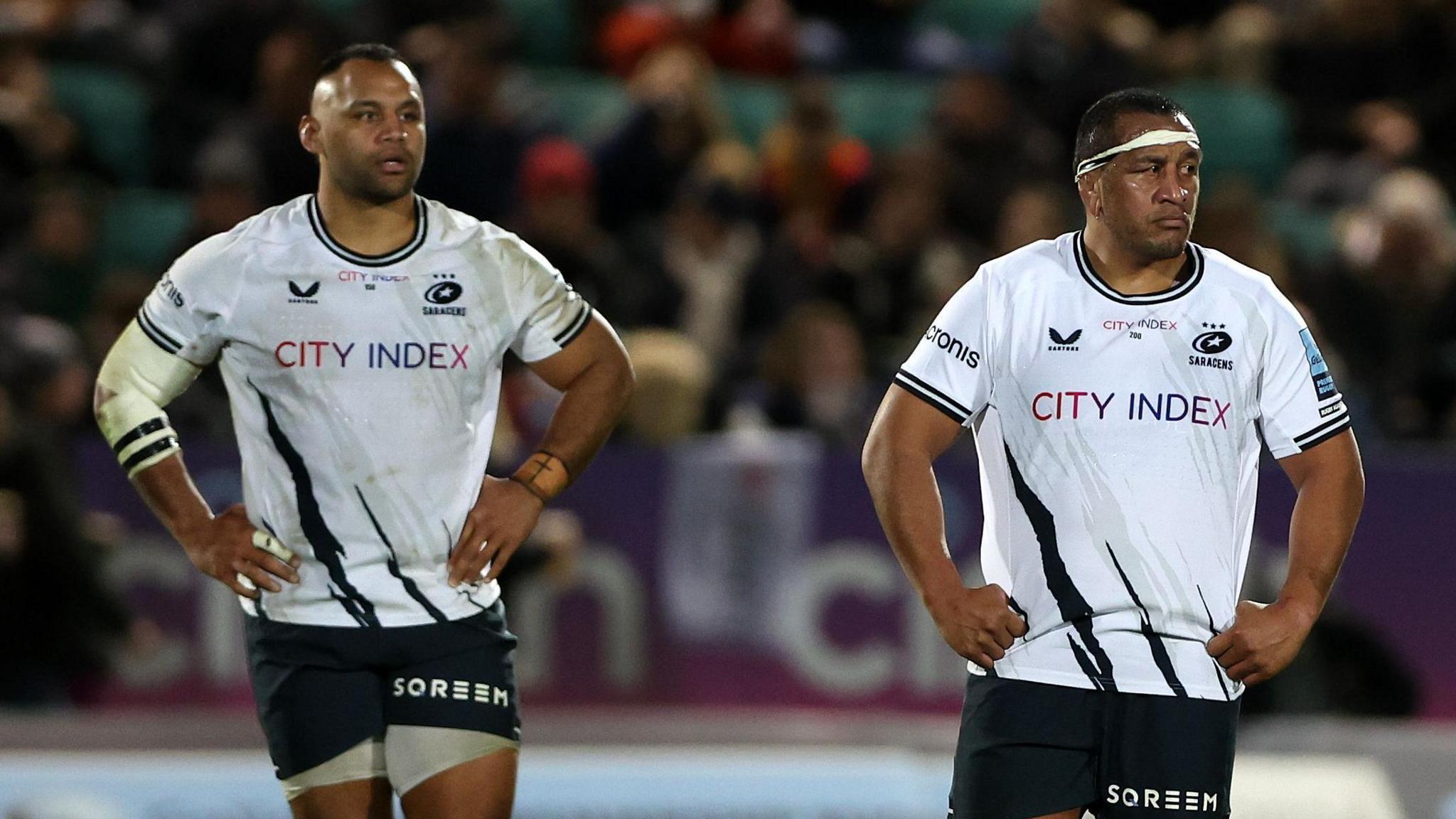 Billy (left) and Mako Vunipola standing on the pitch