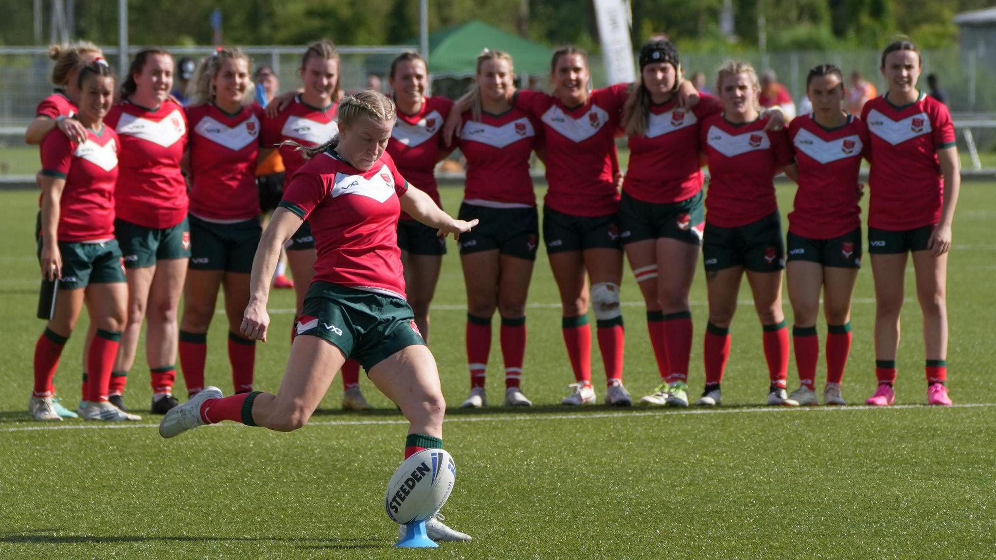 Leanne Burnell kicks the final goal in front of her teammates as Wales qualified for a first World Cup