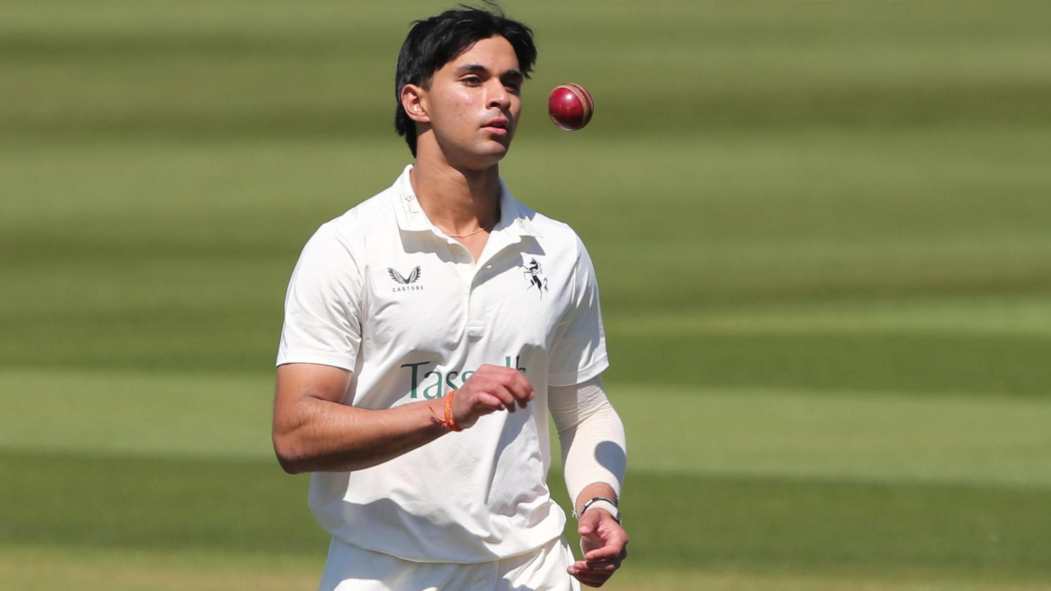 Kansh Singh throws a cricket ball in the air