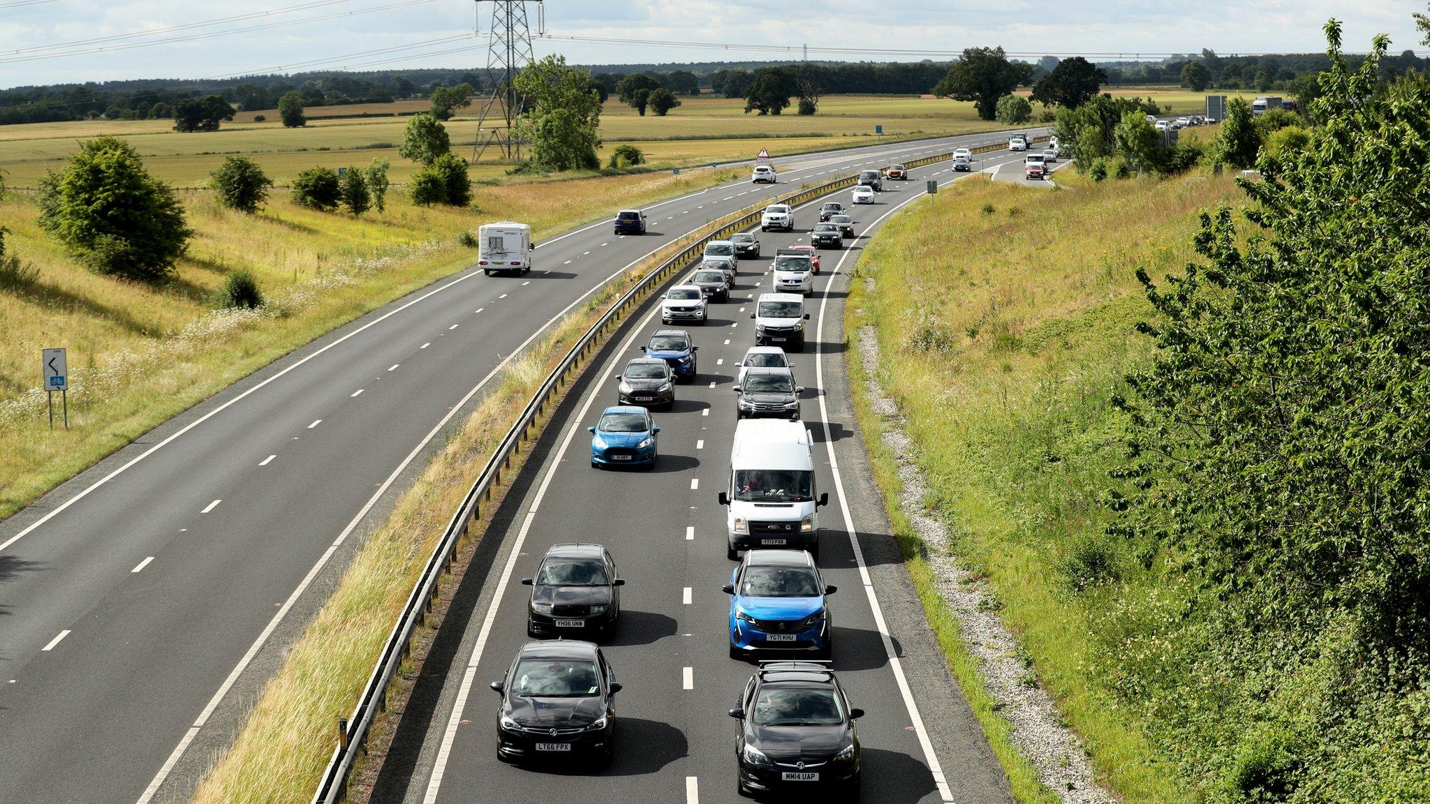 cars moving slowly along a stretch of motorway causing a traffic jam