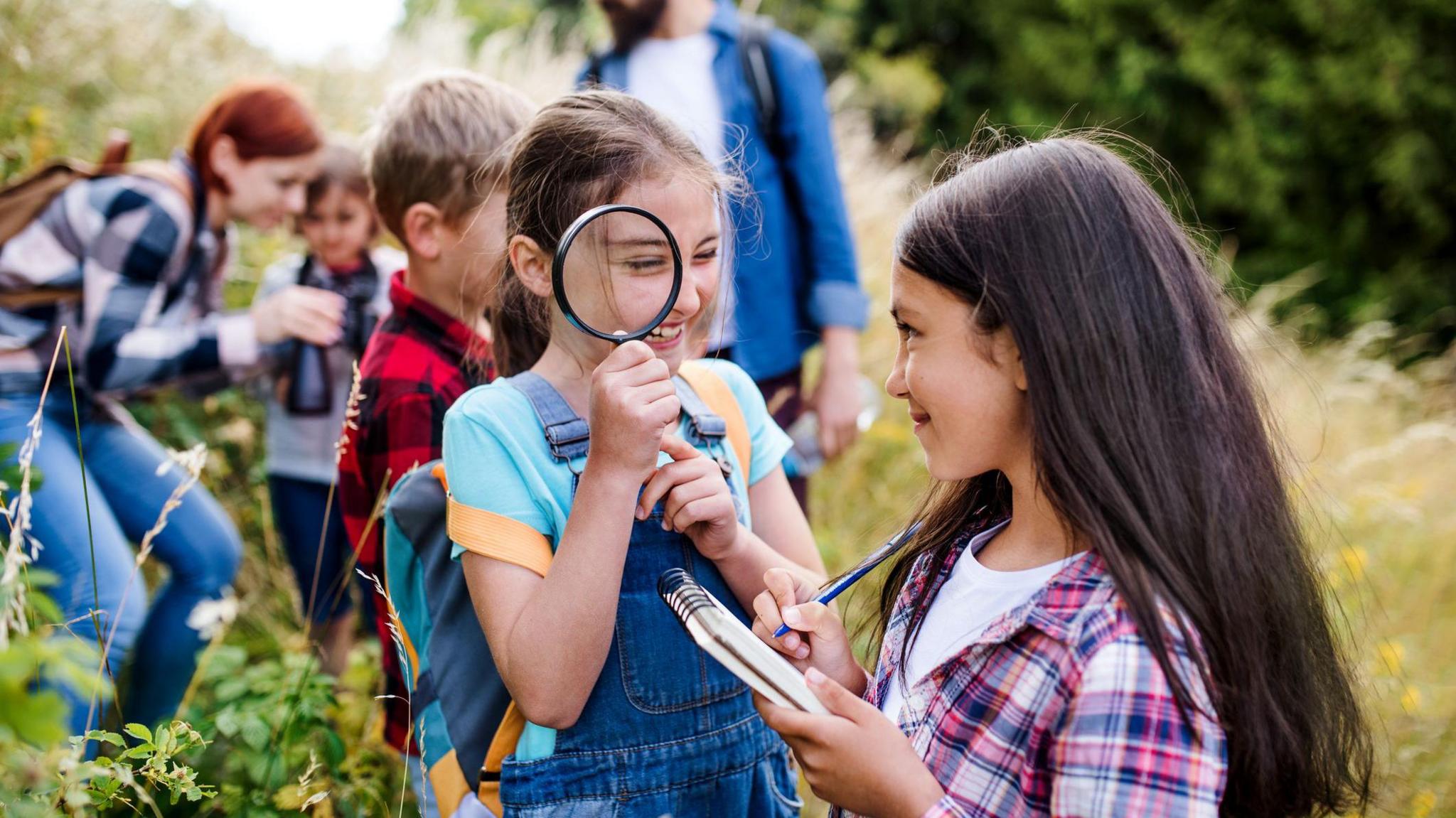 Children with teachers outside in nature. 