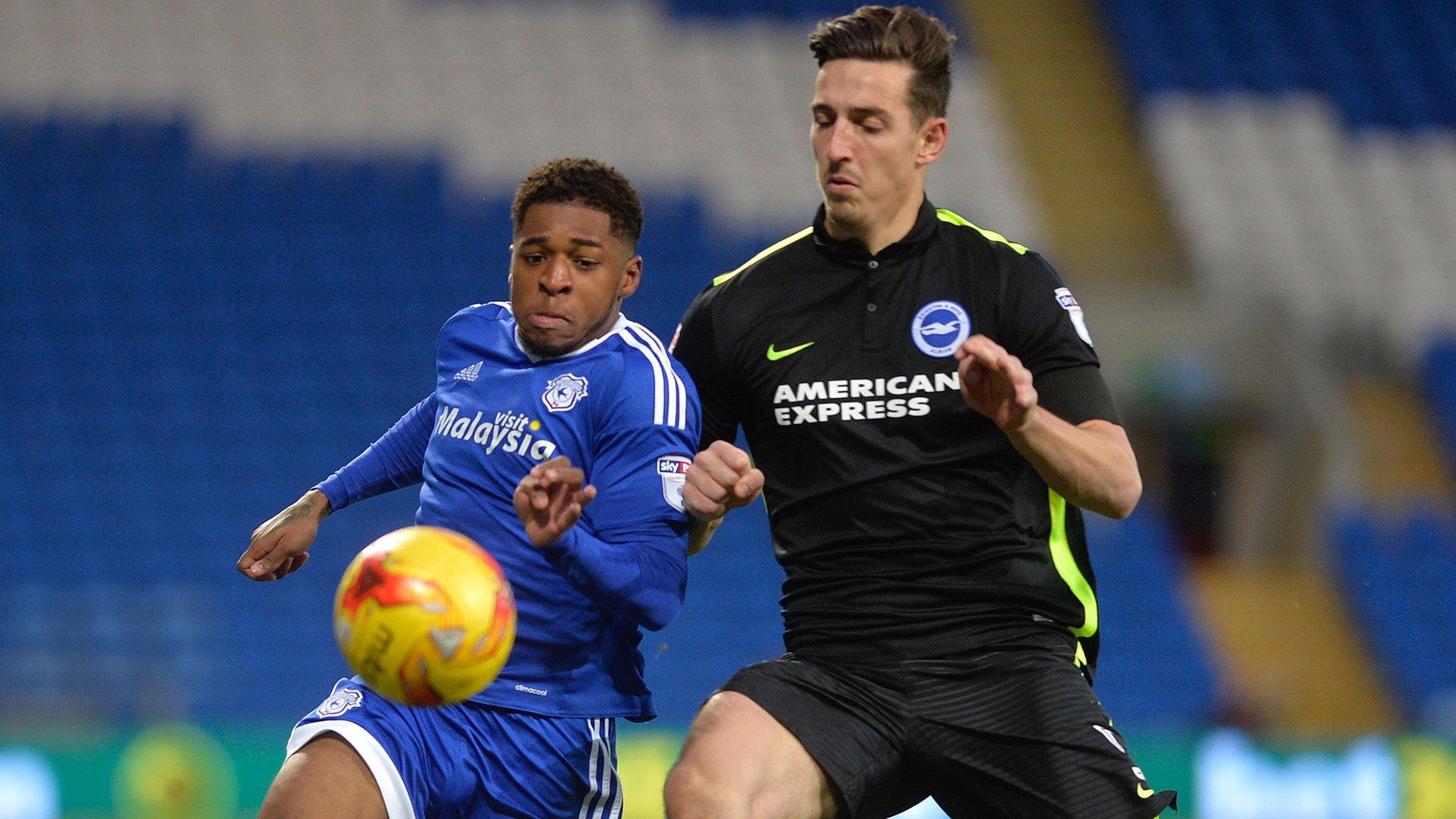 Lewis Dunk of Brighton battles for the ball with Cardiff's Kadeem Harris