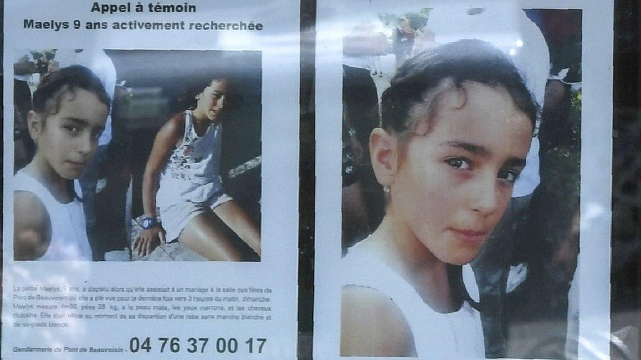 Woman looks at a poster for Maëlys de Araujo in Pont-de-Beauvoisin, eastern France, on August 28, 2017