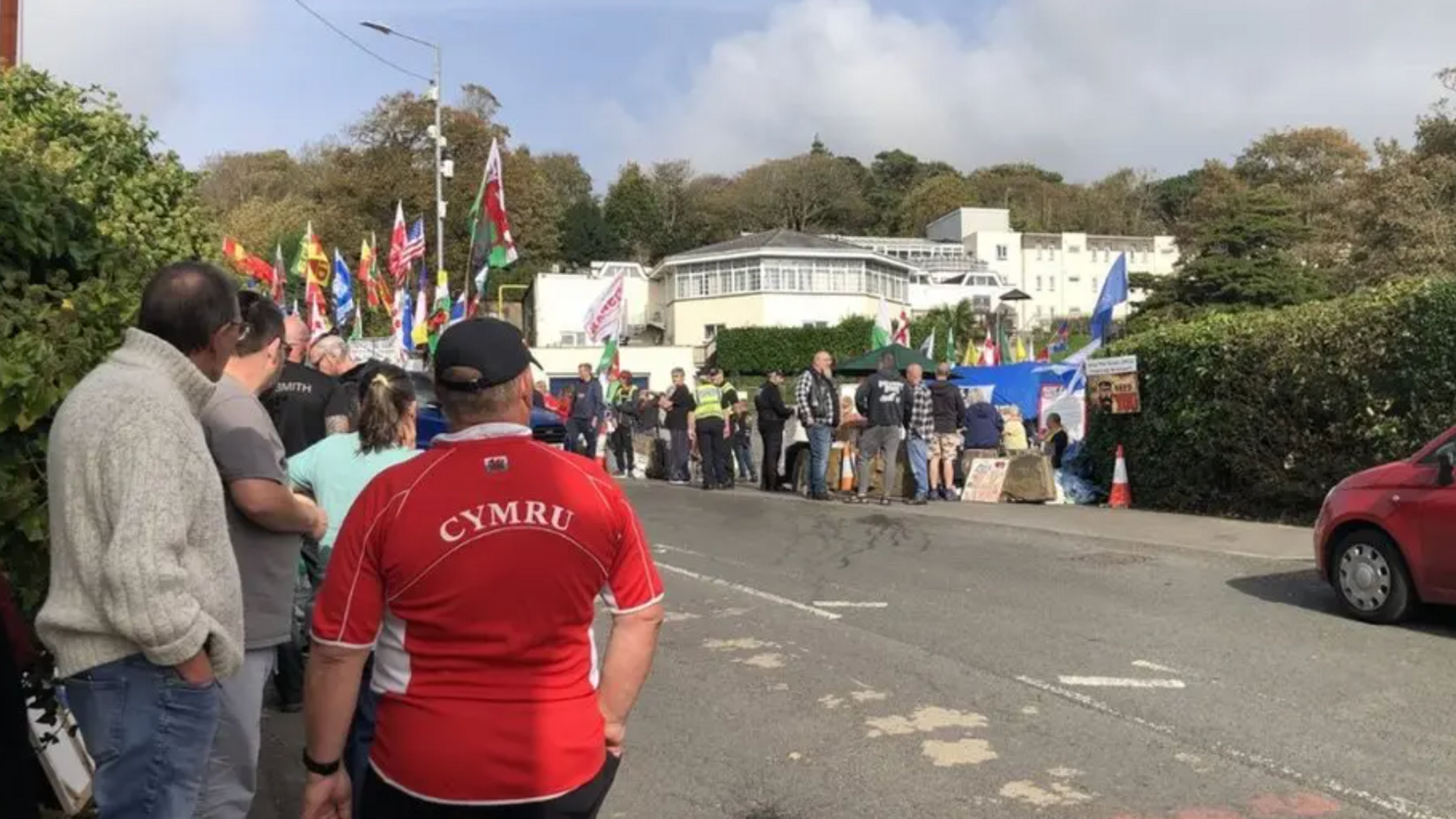 Protesters gather outside the Stradey Park Hotel in Llanelli when plans to use it for temporary housing for  asylum seekers was announced.  