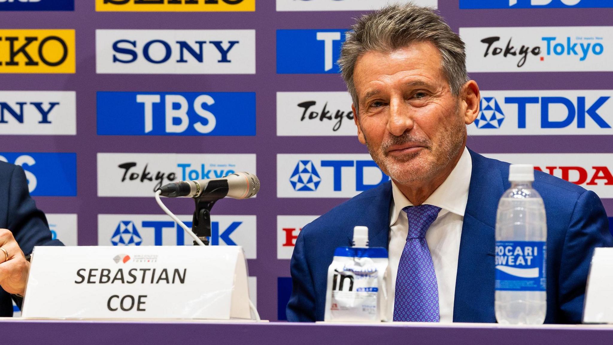 Sebastian Coe sitting behind a table at a media conference
