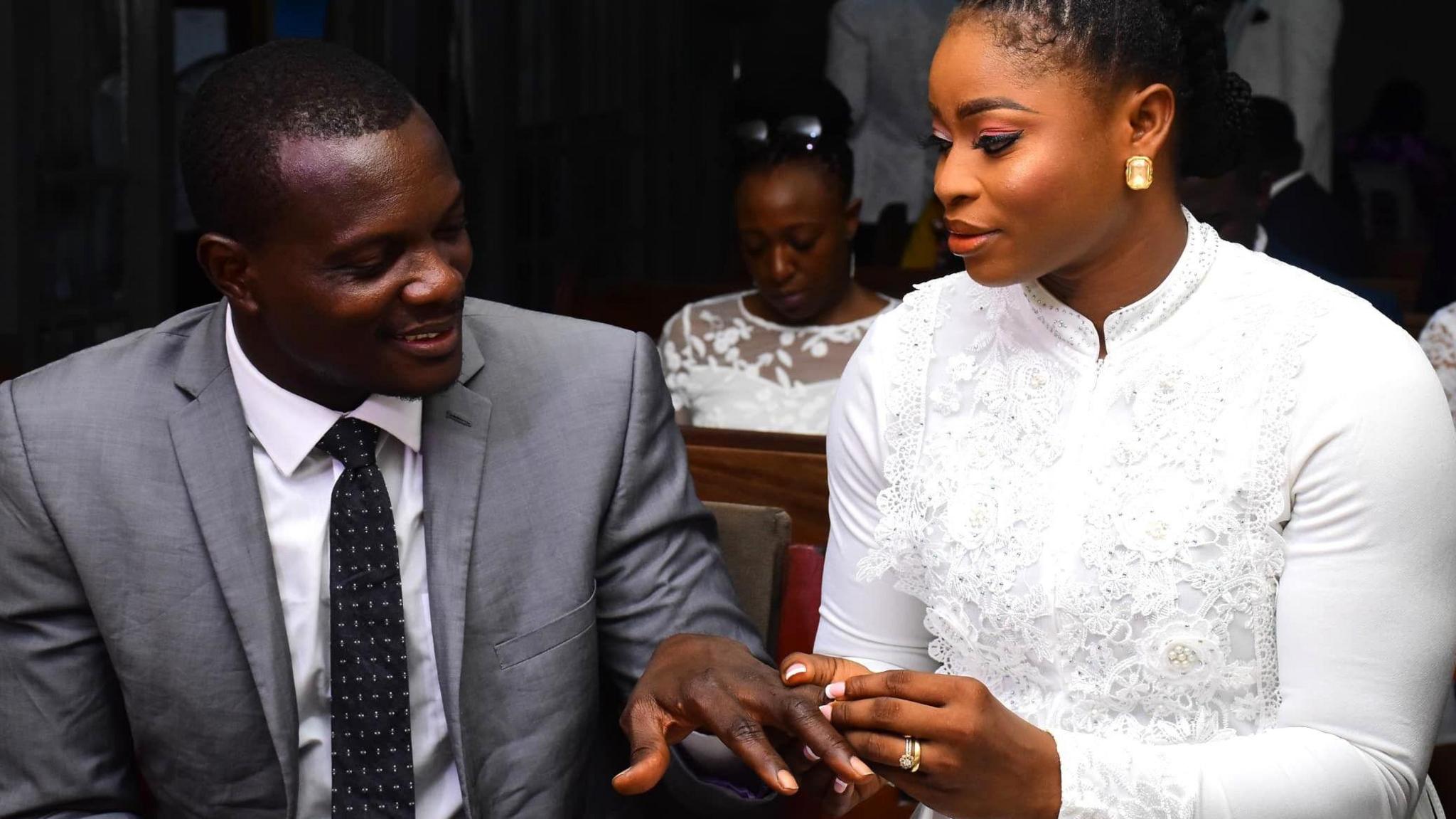 Christiana Alabi places a ring on Kayode's finger during their wedding service