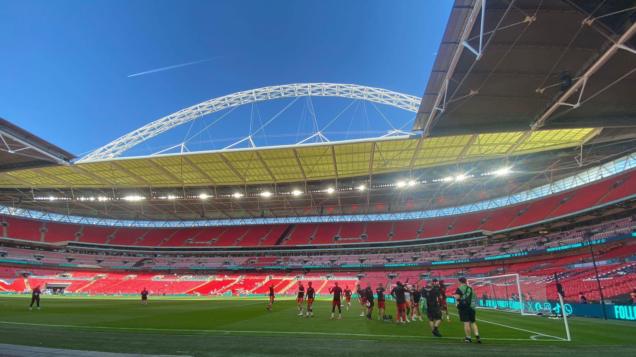 Pitch side at a large football stadium.