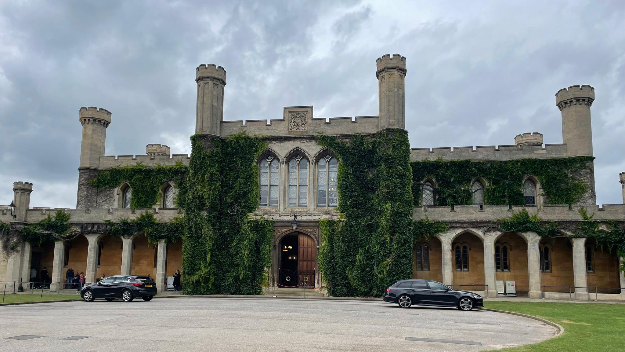 Lincoln Crown Court a two-storey Victorian Gothic building with stone pillars, crenellated roof and six towers with ivy growing up its walls