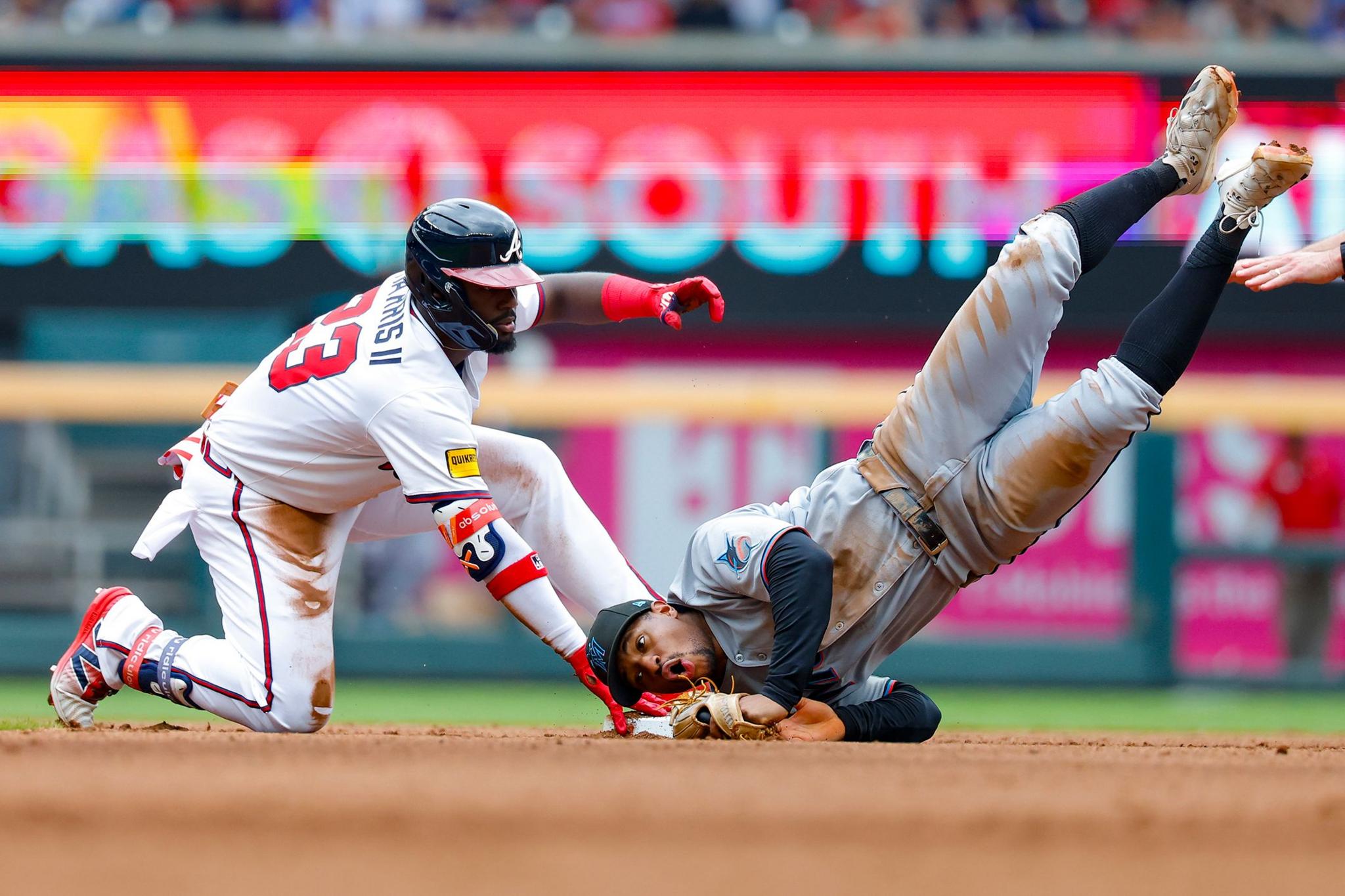 Atlanta Braves' Michael Harris II reaches second base for a double as Miami Marlins' Xavier Edwards applies a tag during the fourth inning at Truist Park in Atlanta, Georgia. Photo by Todd Kirkland