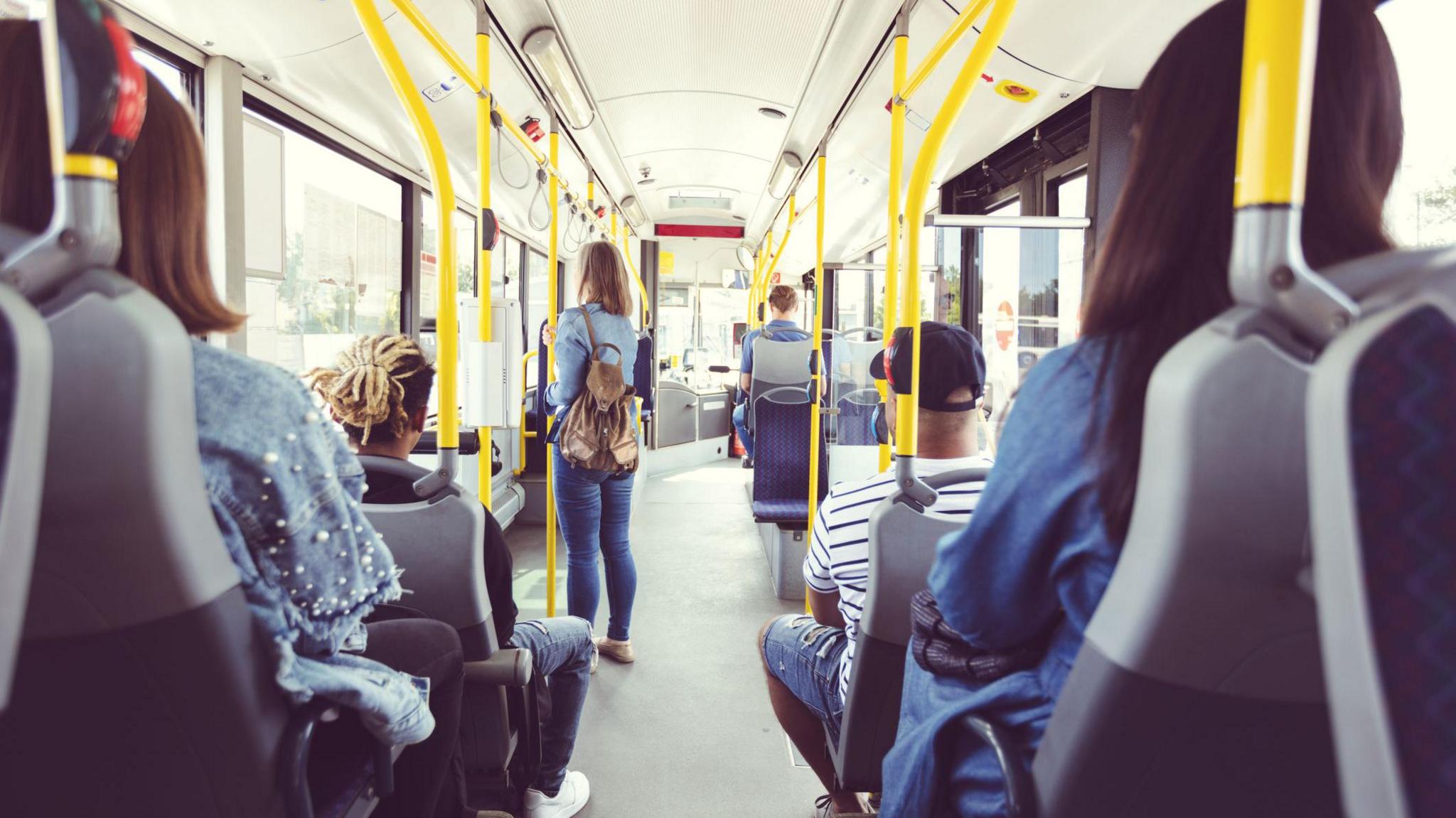 Bus passengers standing and sitting