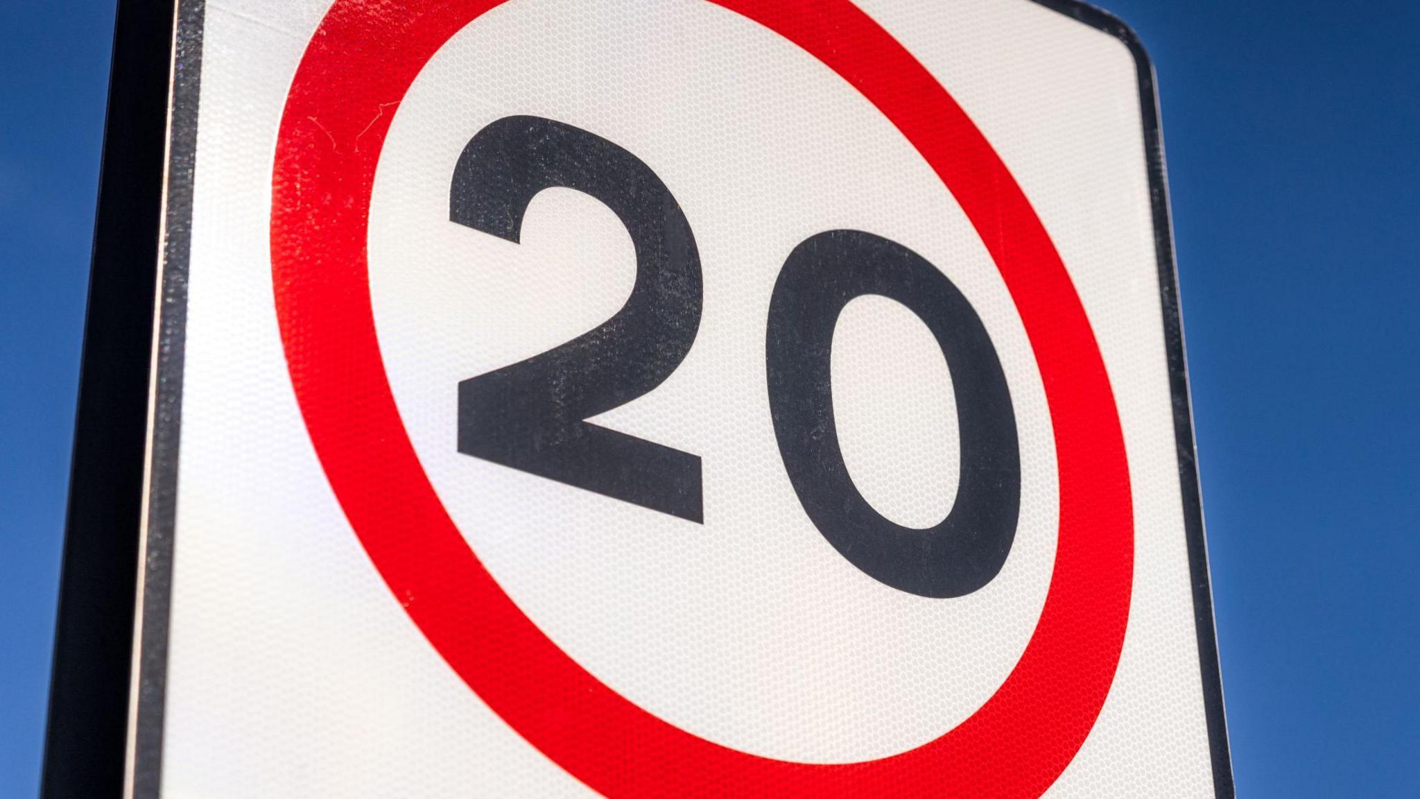 The number 20 in black on a white background and in a red circle.