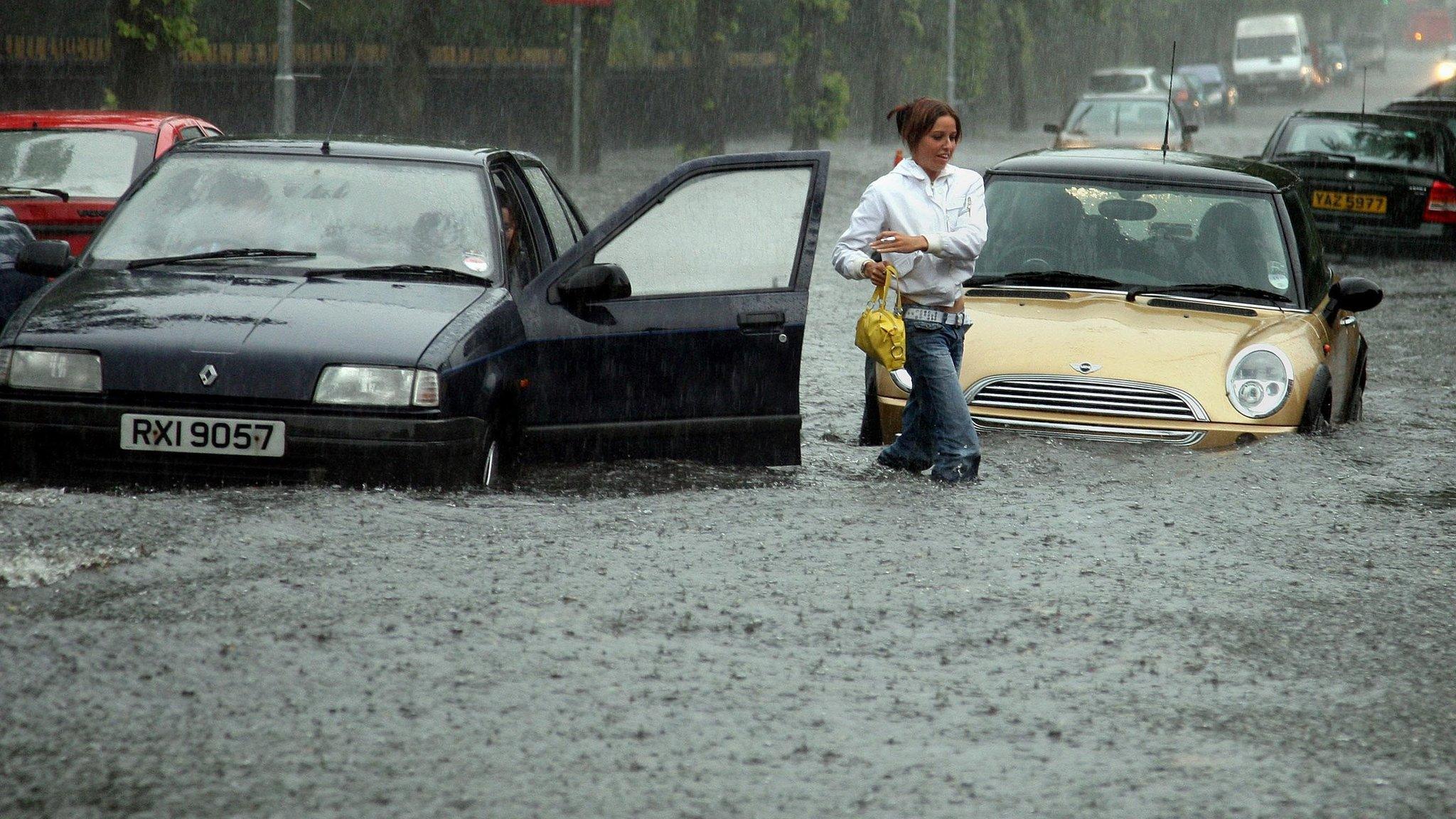 A woman leaves her car in Park Road, east Belfast, during severe flooding in 2007