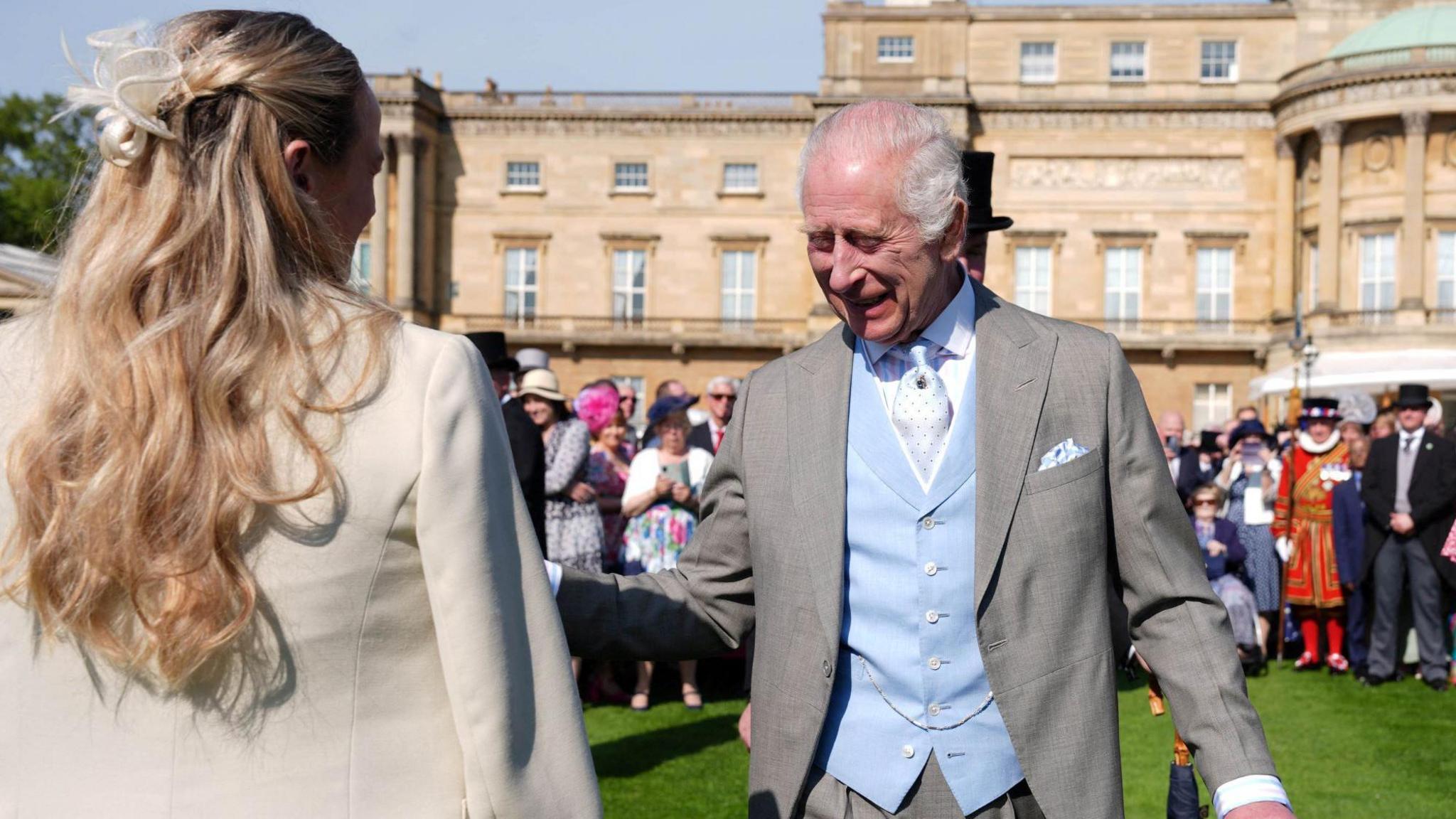 King Charles on the lawn at a Buckingham Palace party