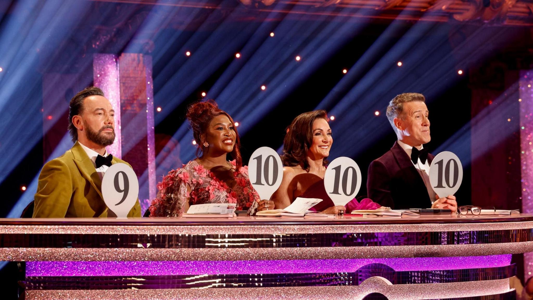 Strictly judges Craig Revel Horwood, Motsi Mabuse, Shirley Ballas and Anton Du Beke holding paddles with 10s and a 9 on them.