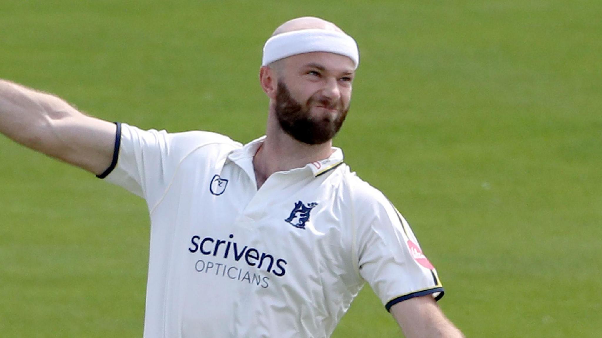 Warwickshire's Michael Rae warms up as he prepares to bowl