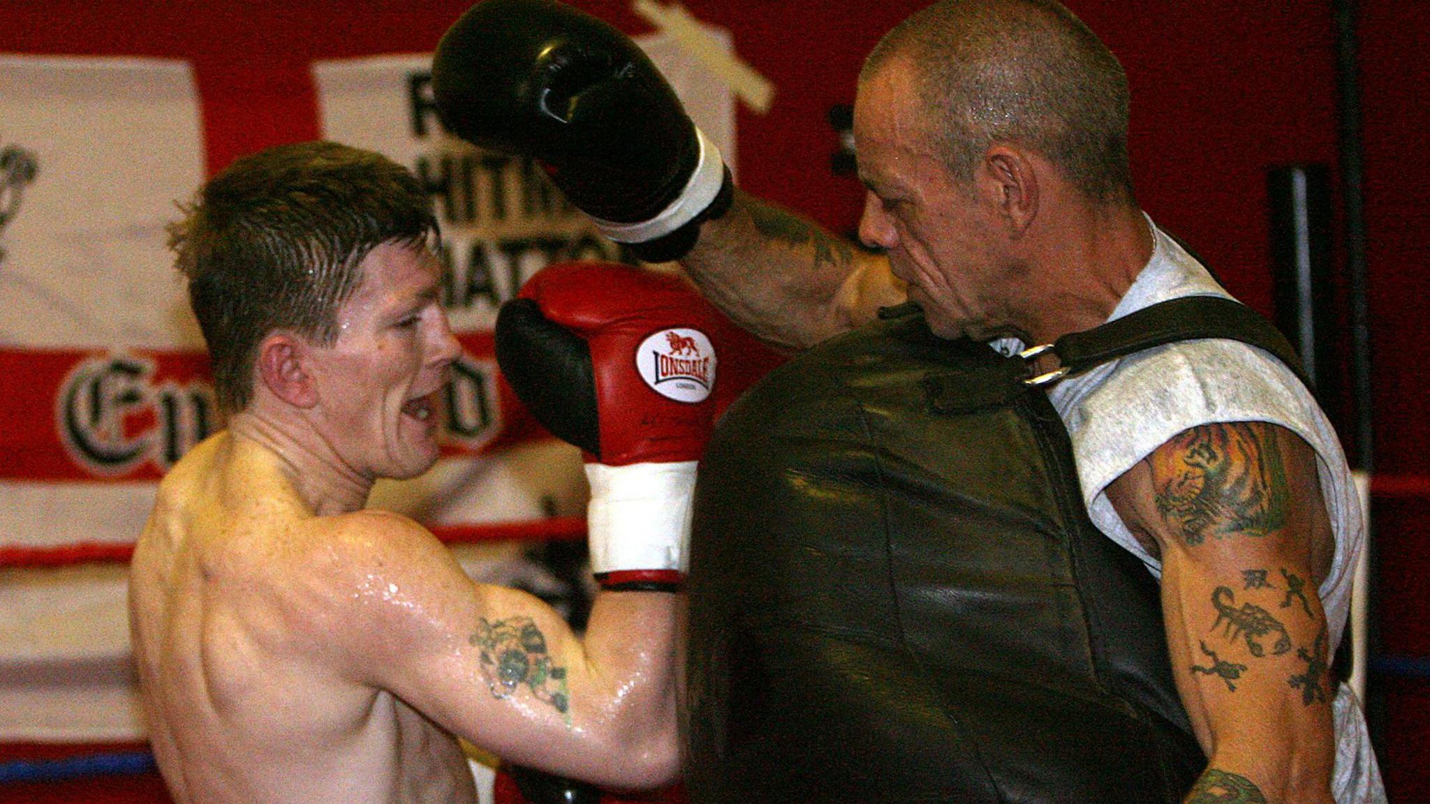 Ricky Hatton and Billy Graham in the gym with a punching bag