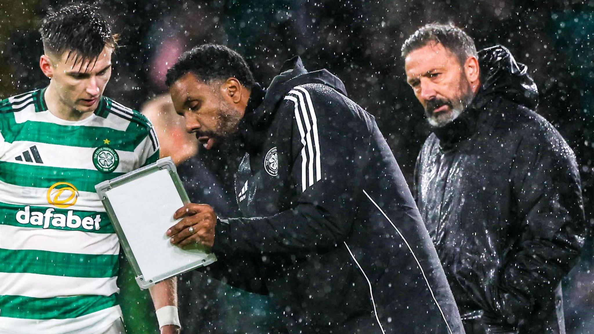 Celtic manager Wilfried Nancy issues instructions to Kieran Tierney as Hearts head coach Derek McInnes looks on