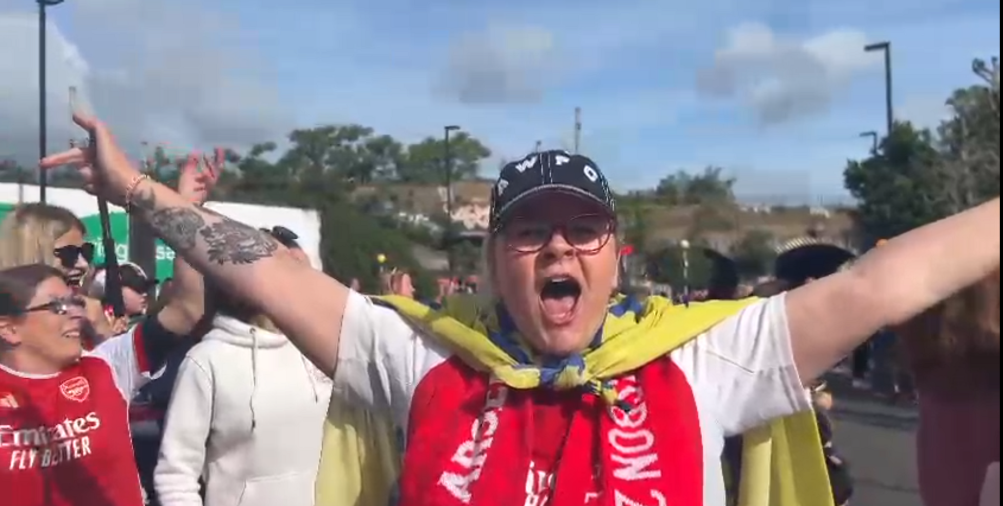 Kate Sheard holding her arms out and cheering