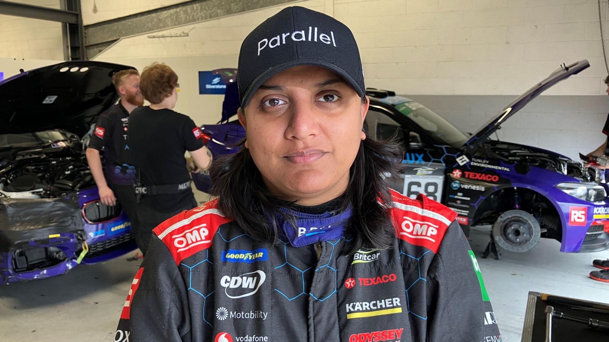 Asha Silva wearing a cap that says "parallel"