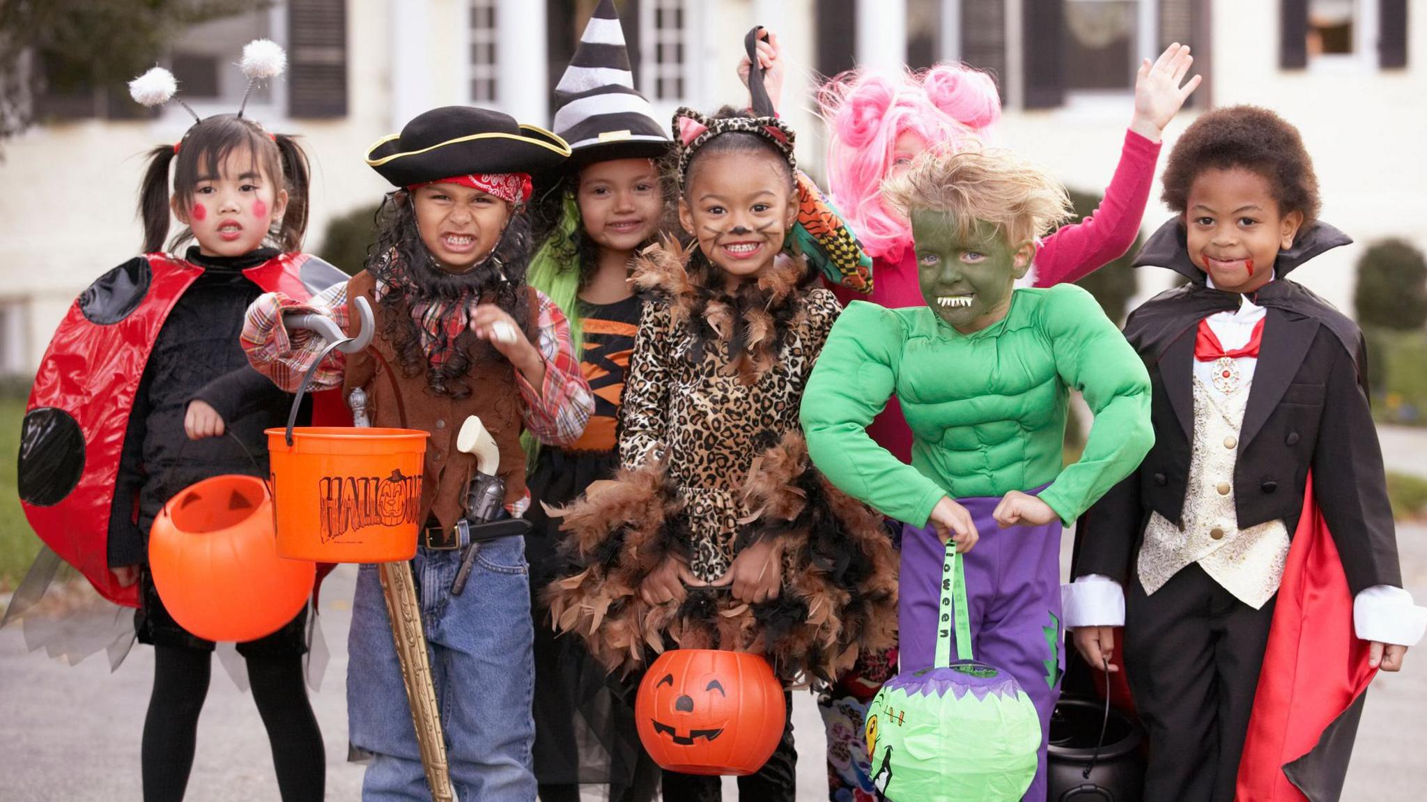 children dressed in Halloween costumes