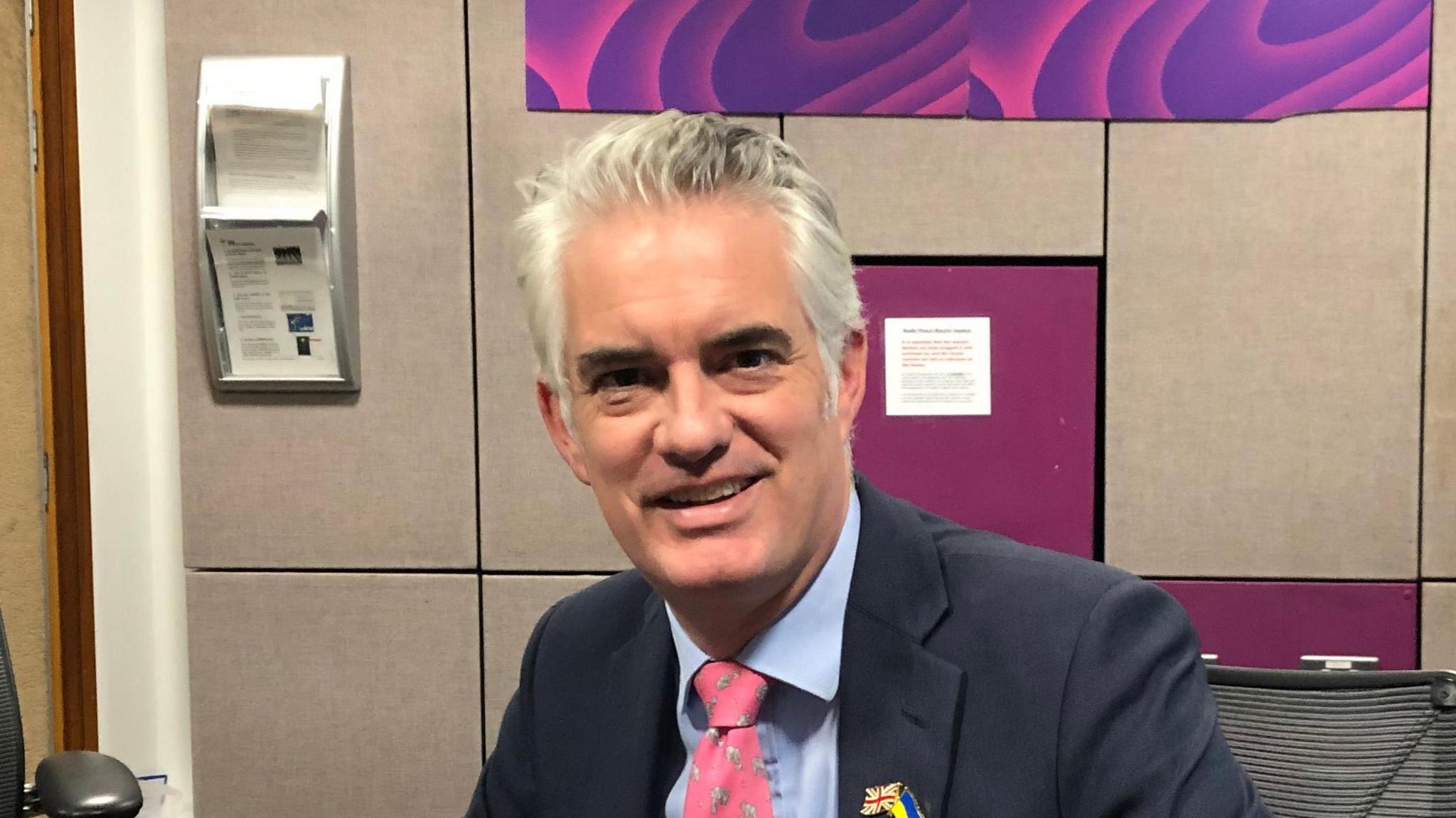 MP James Cartlidge wearing a navy suit during a visit to the BBC Radio Suffolk studio in Ipswich.