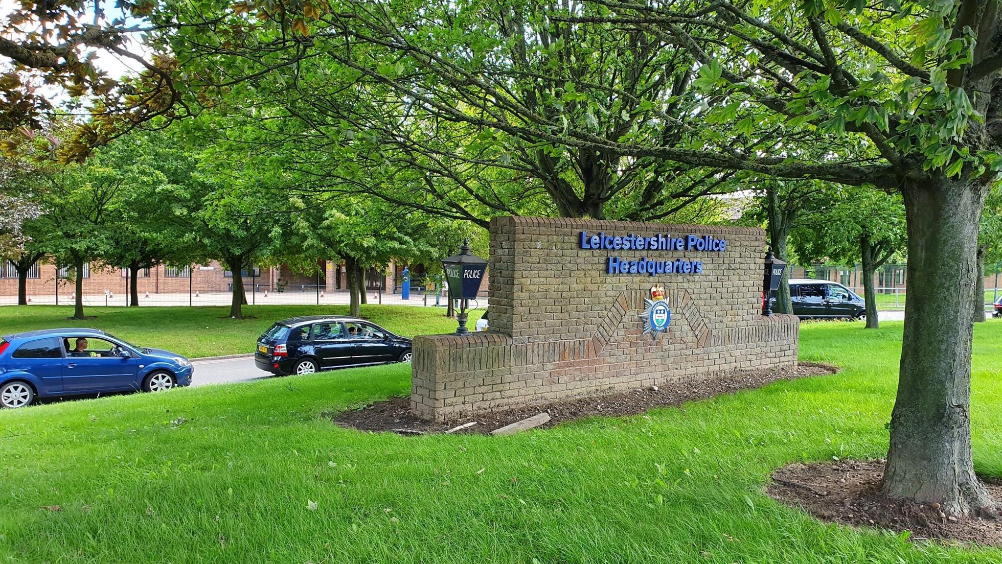 The sign on a brick wall at the entrance to Leicestershire Police HQ