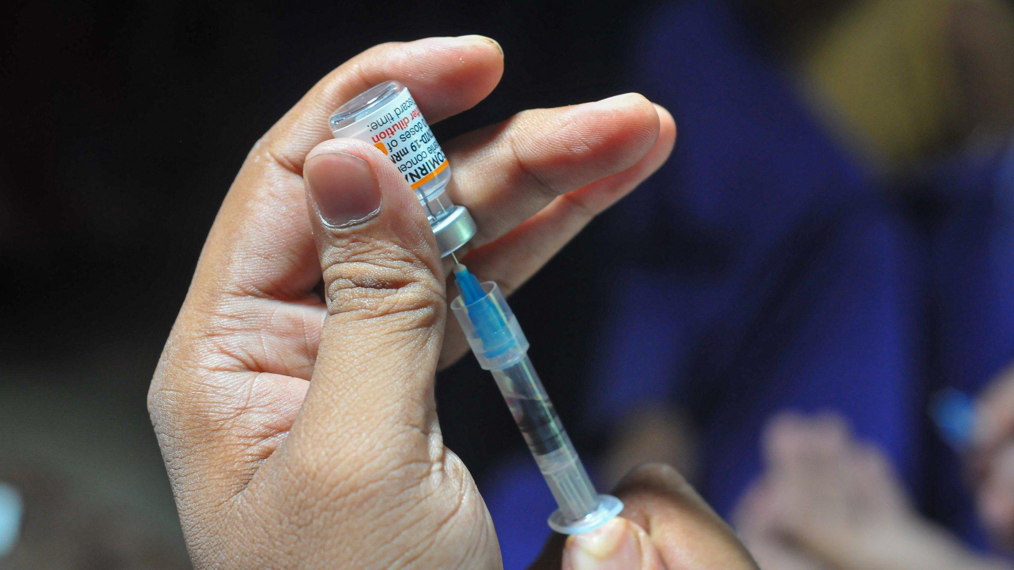 A health worker prepares a dose of Pfizer Covid-19 vaccine