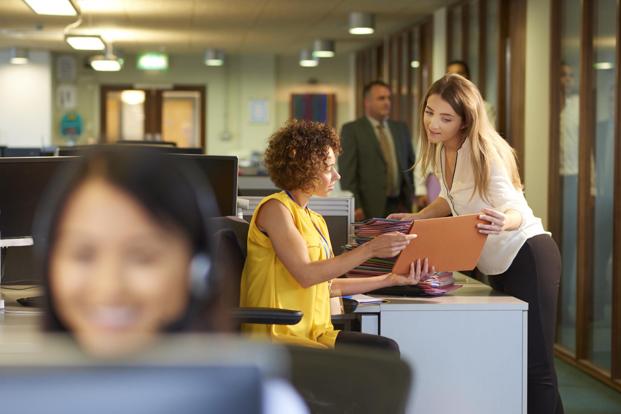 Office workers discuss something