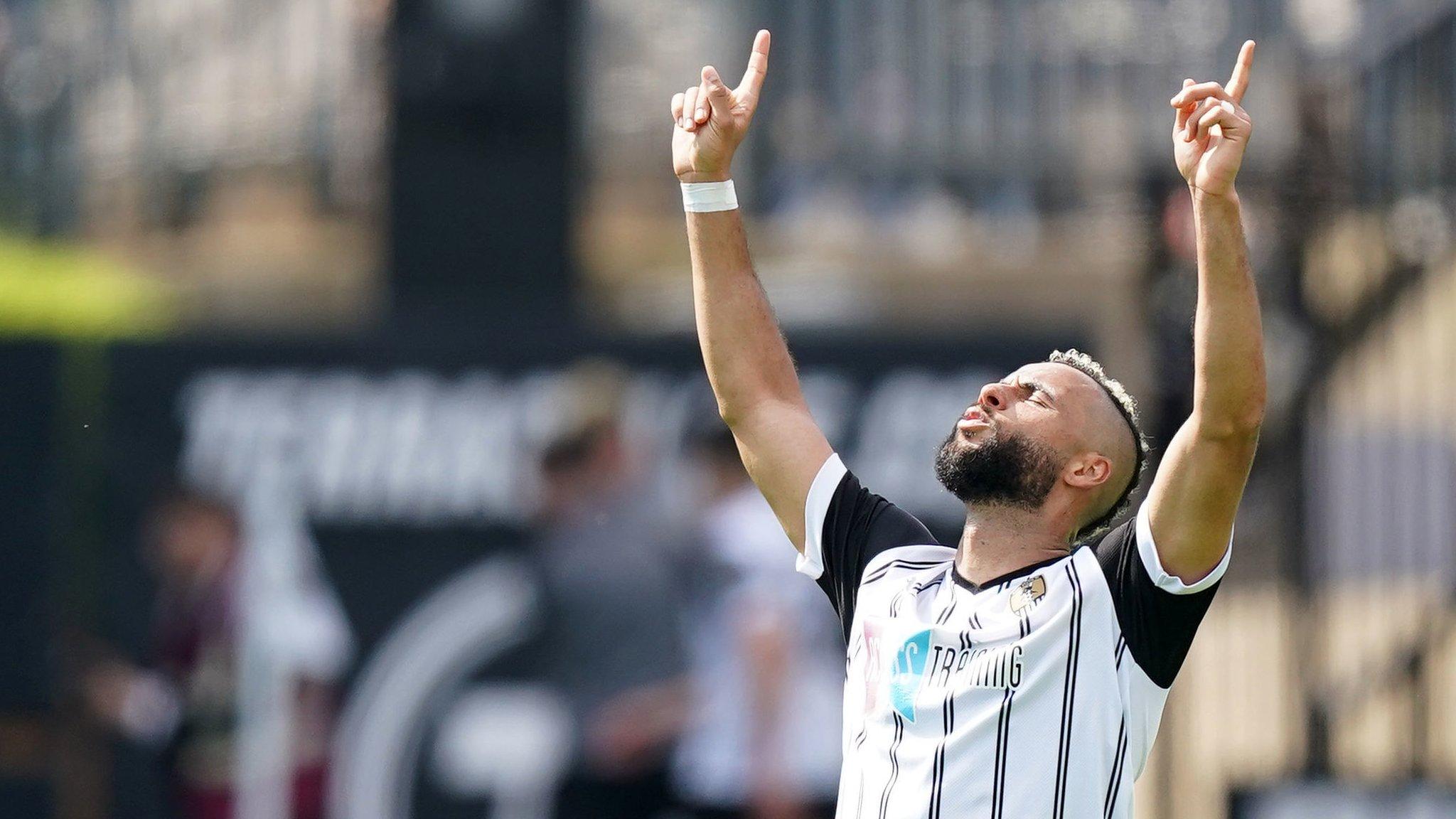 Notts County's John Bostock slumps to his knees in relief as the Magpies equalise against Boreham Wood