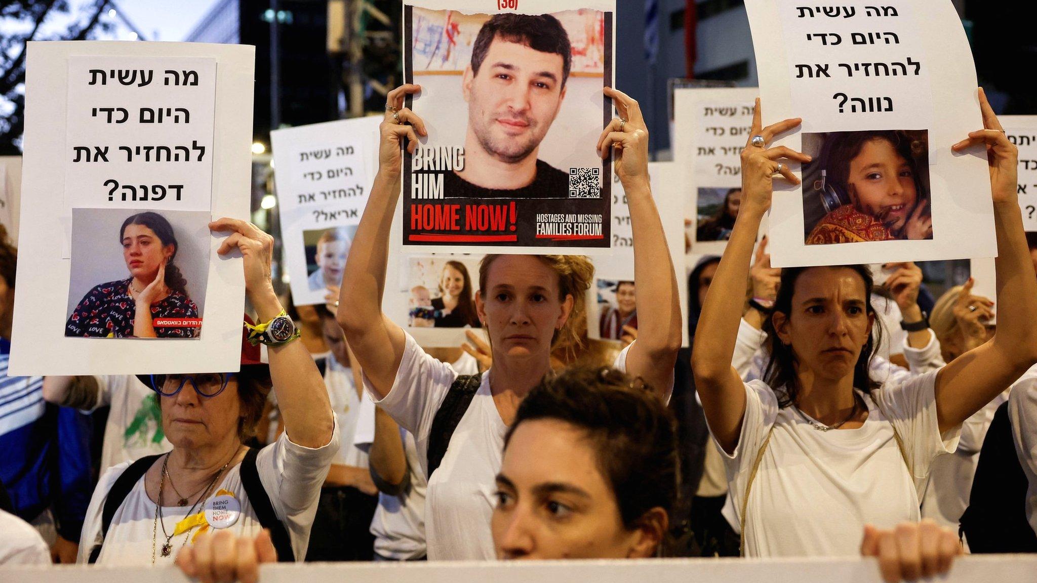 Protesters in Tel Aviv, Israel, hold signs demanding the release of hostages being held by Hamas in Gaza (21 November 2023)